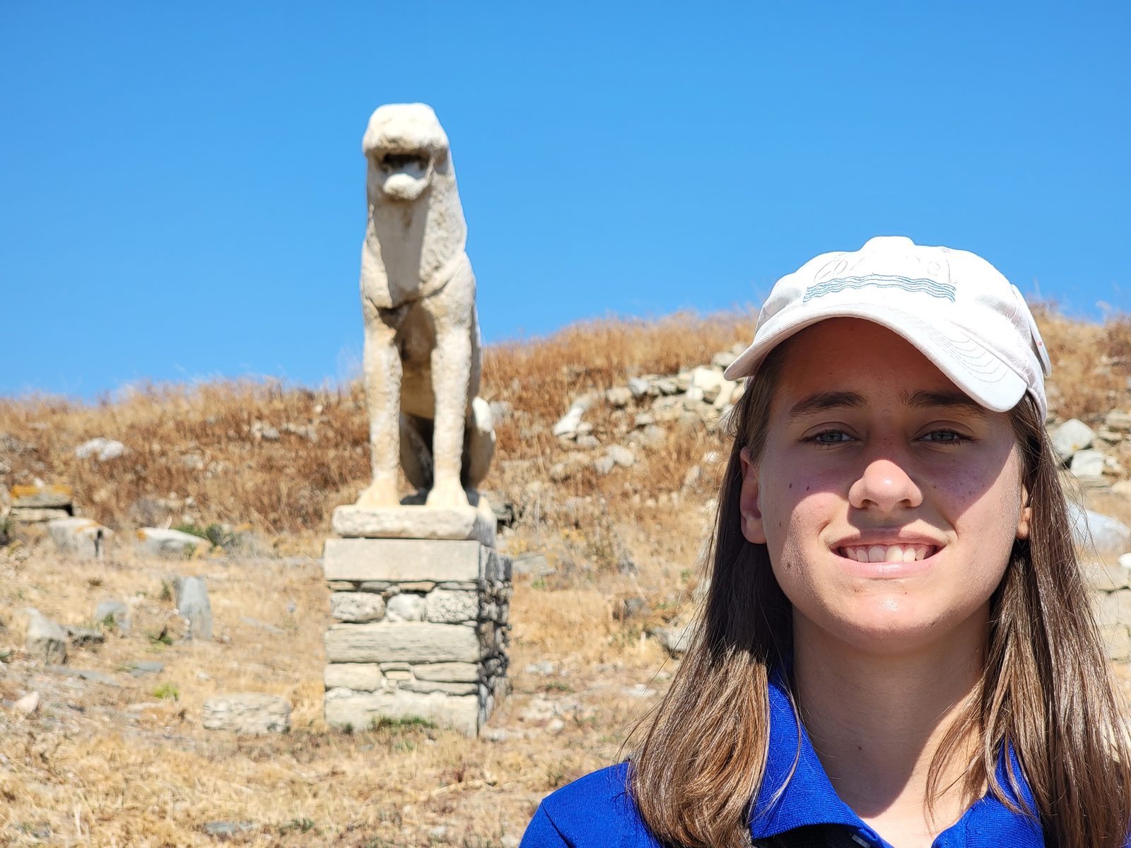 Lisa beside one of the lions on Delos
