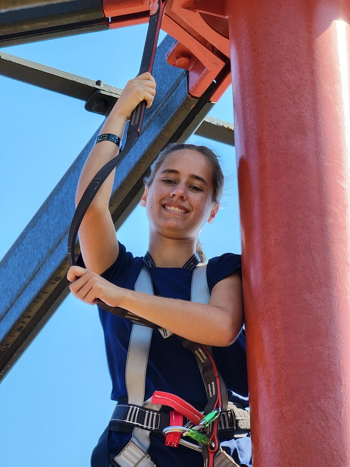 Lisa harnessed on the ropes course