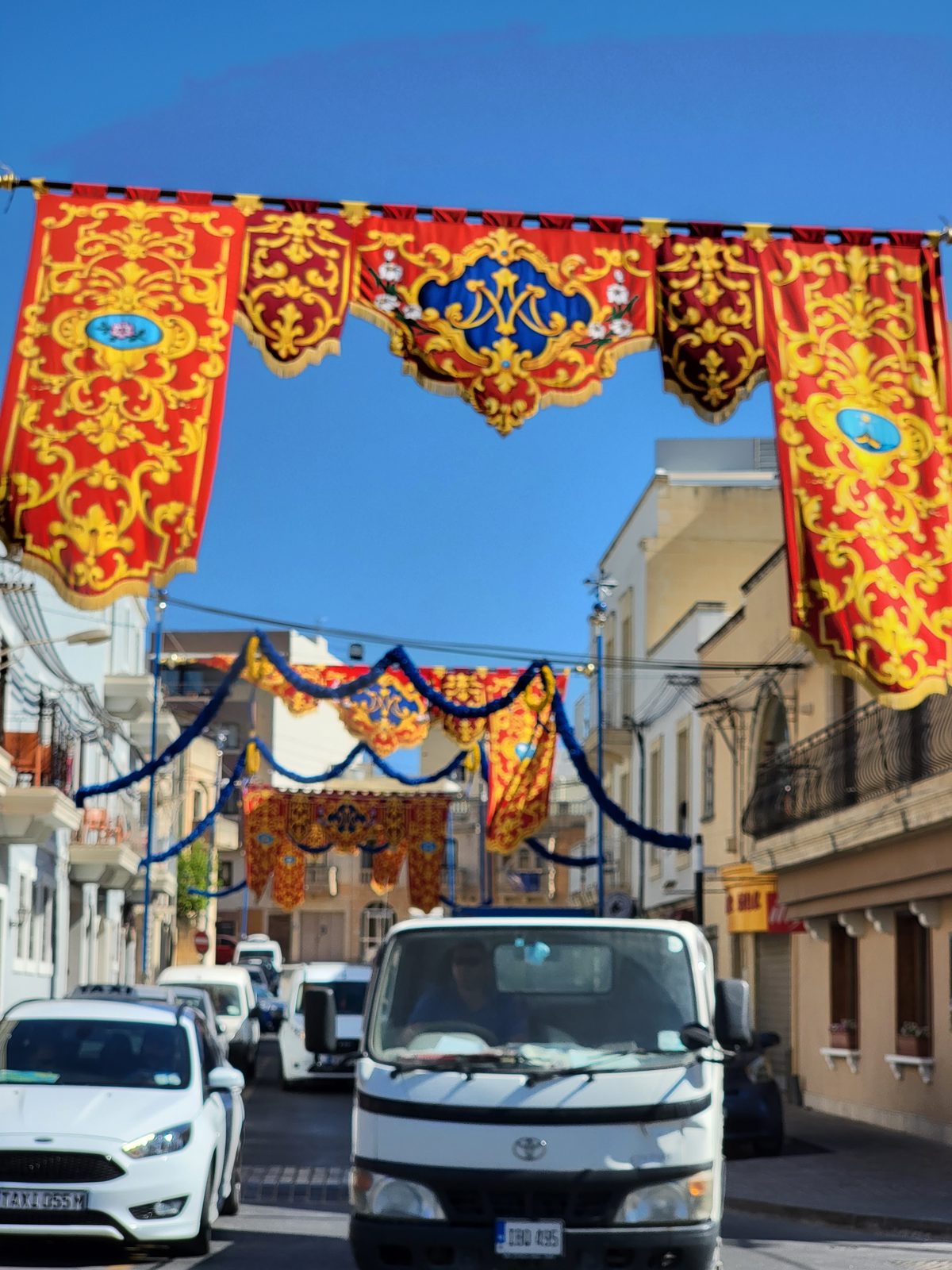 Festival banners over a street in Marsaxlokk