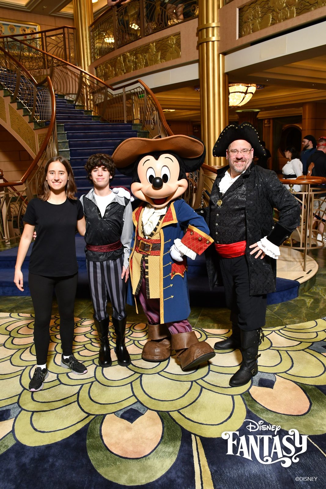 Lisa, Thomas, Mickey in pirate garb and Michael on Pirate Night in the Lobby Atrium