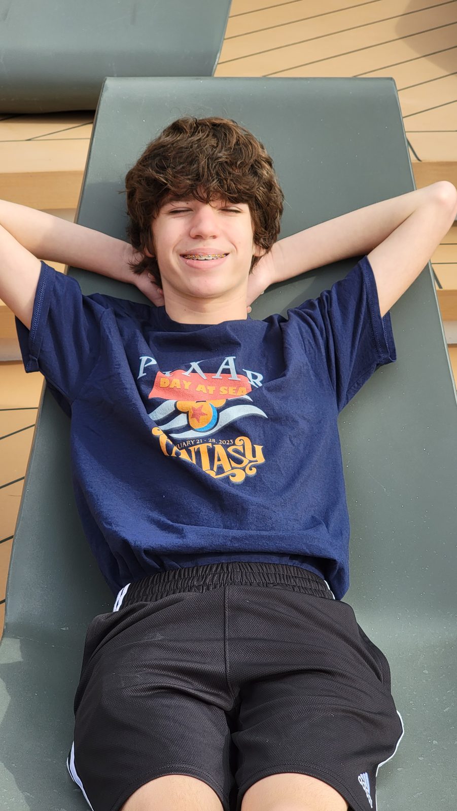 Thomas stretched out on a deck lounger aboard the Fantasy