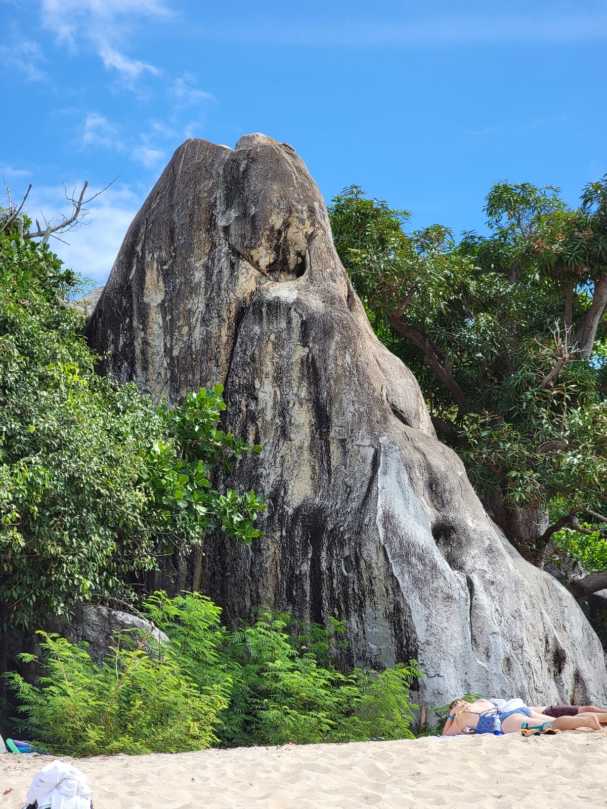 A granite spire above the beach at The Baths