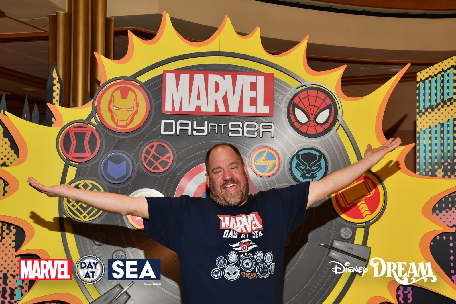 Michael in front of the Marvel Day at Sea sign on the Disney Dream