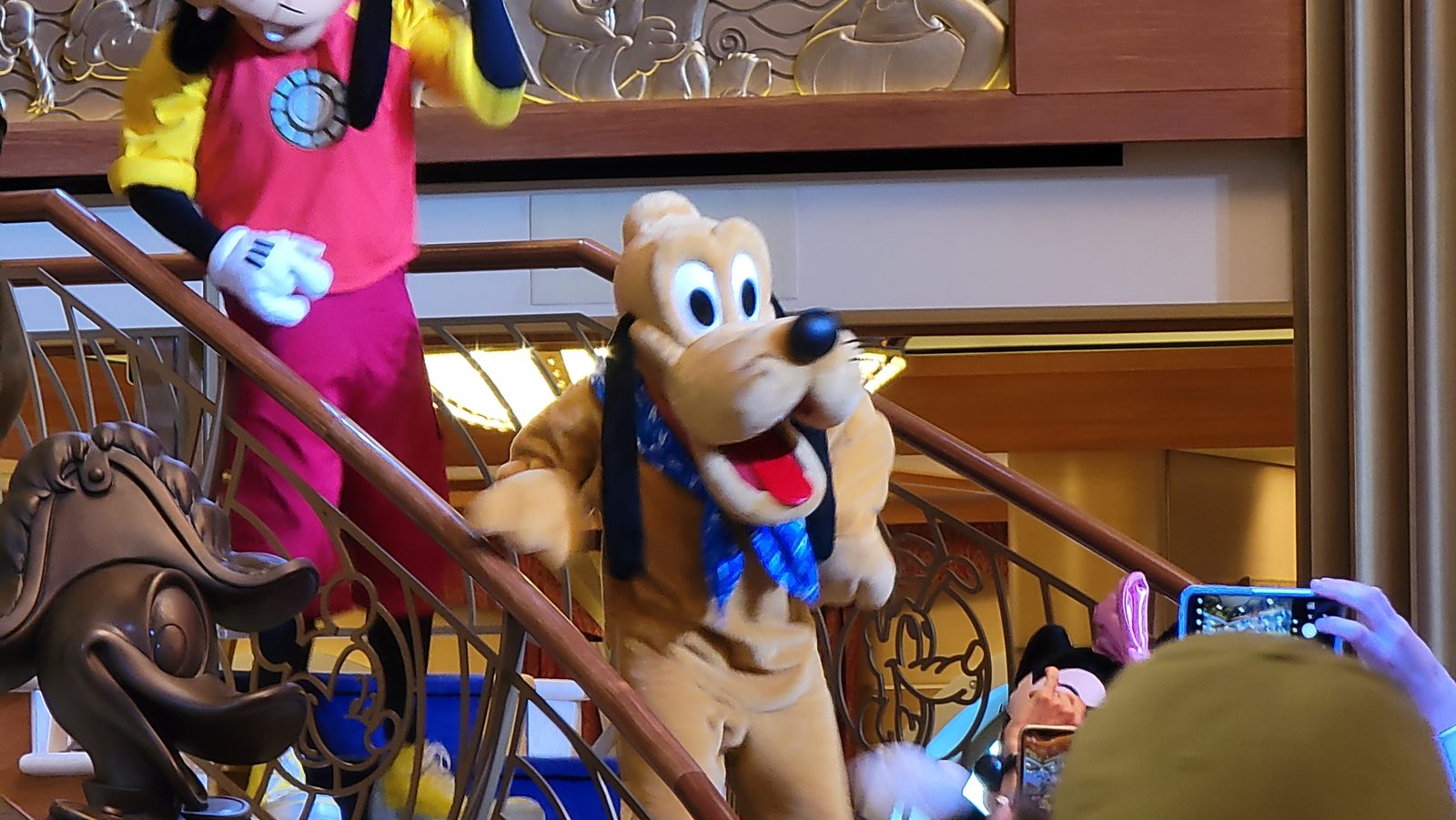 Goofy in his Iron Man outfit and Pluto on the Lobby Atrium staircase on Marvel Day at Sea