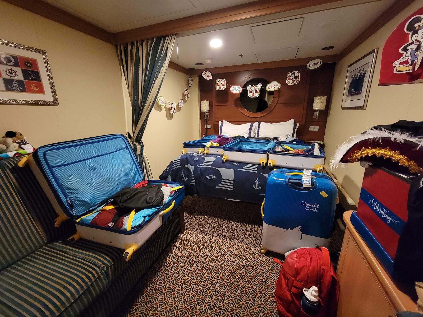 Suitcases open in our stateroom on the last sea day