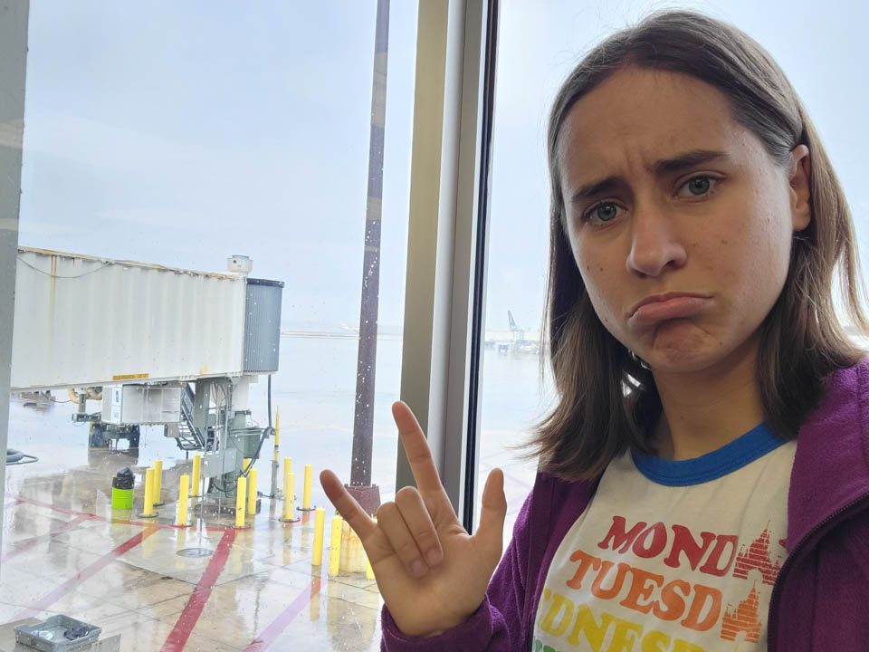Lisa signs I love you before the flight home