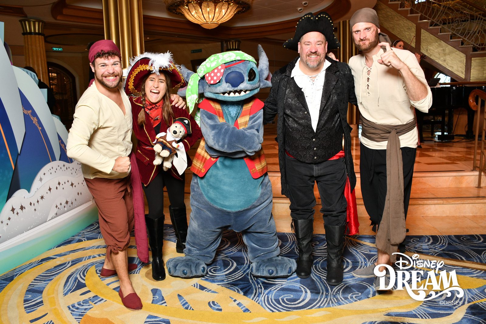 Lisa holding Bob, Stitch in pirate garb and Michael on Pirate Night in the Lobby Atrium