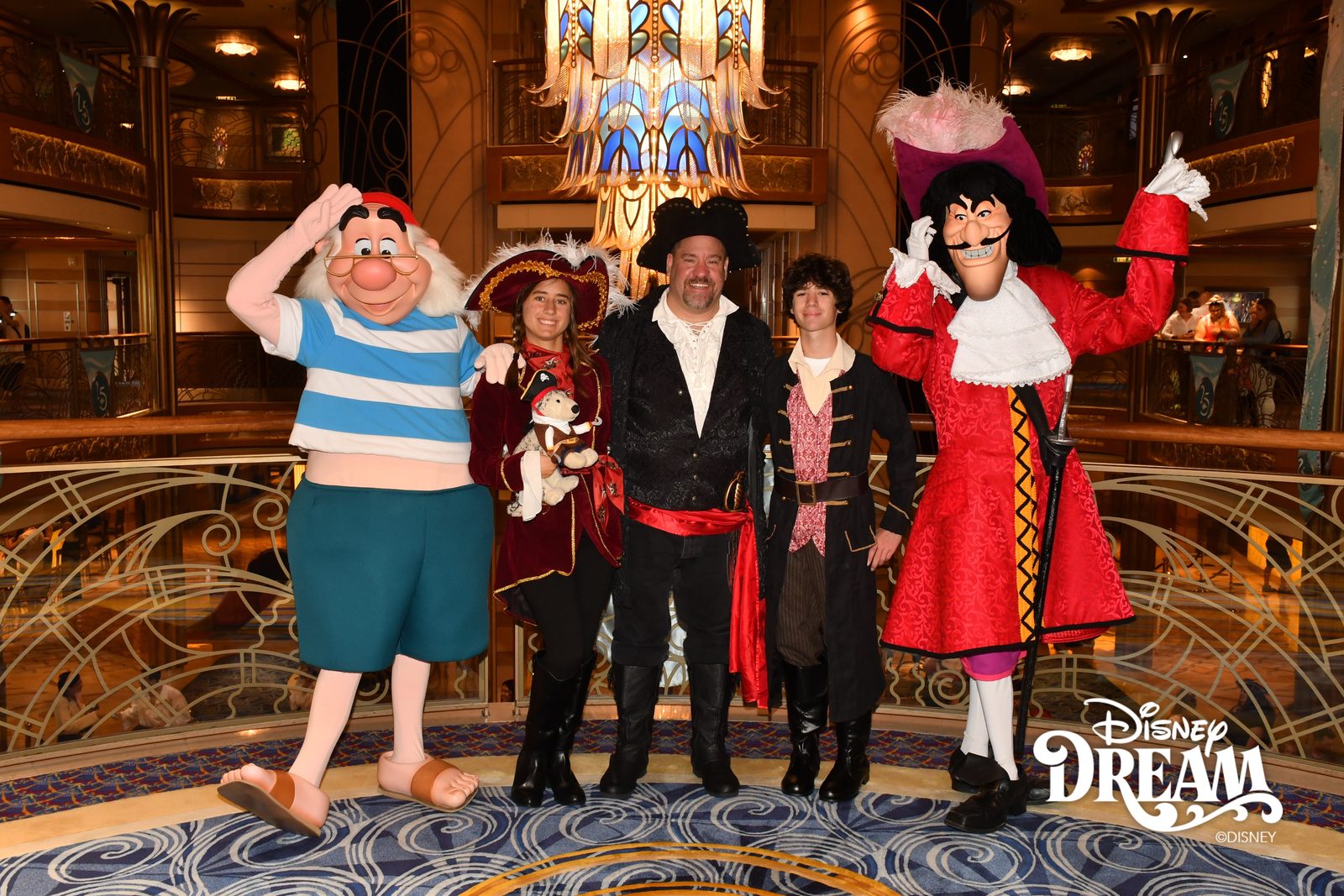 Mr. Smee, Lisa holding Bob, Michael, Thomas and Captain Hook on Pirate Night in the Lobby Atrium