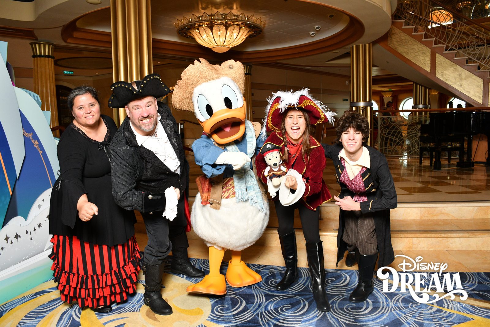 Kathy, Michael, Donald in pirate garb holding Bob, Lisa and Thomas on Pirate Night in the Lobby Atrium