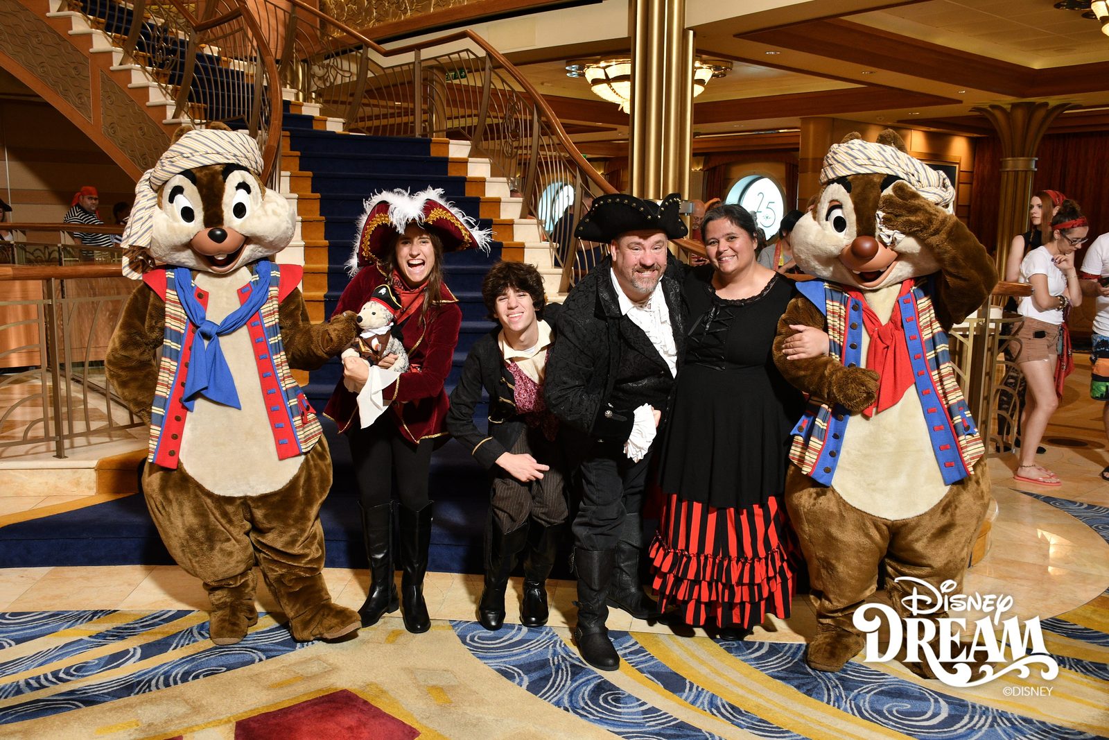 Chip in pirate garb, Lisa holding Bob, Thomas, Michael, Kathy and Dale in pirate garb on Pirate Night in the Lobby Atrium
