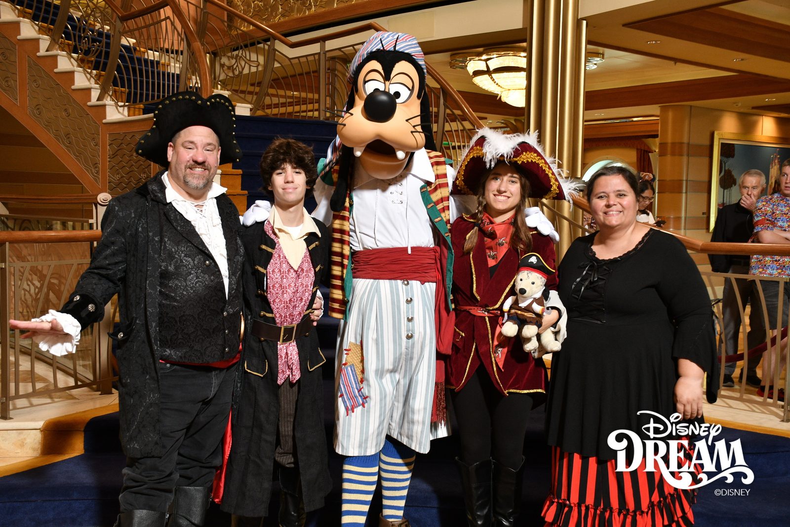 Michael, Thomas, Goofy in pirate garb, Lisa holding Bob and Kathy on Pirate Night in the Lobby Atrium