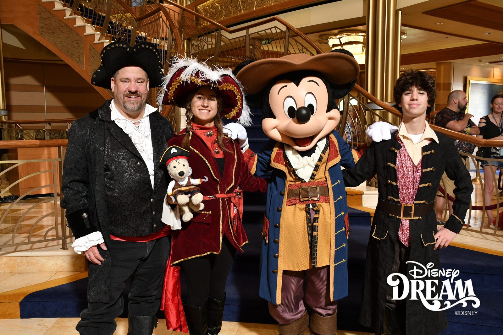 Michael, Lisa holding Bob, Mickey in pirate garb and Thomas on Pirate Night in the Lobby Atrium
