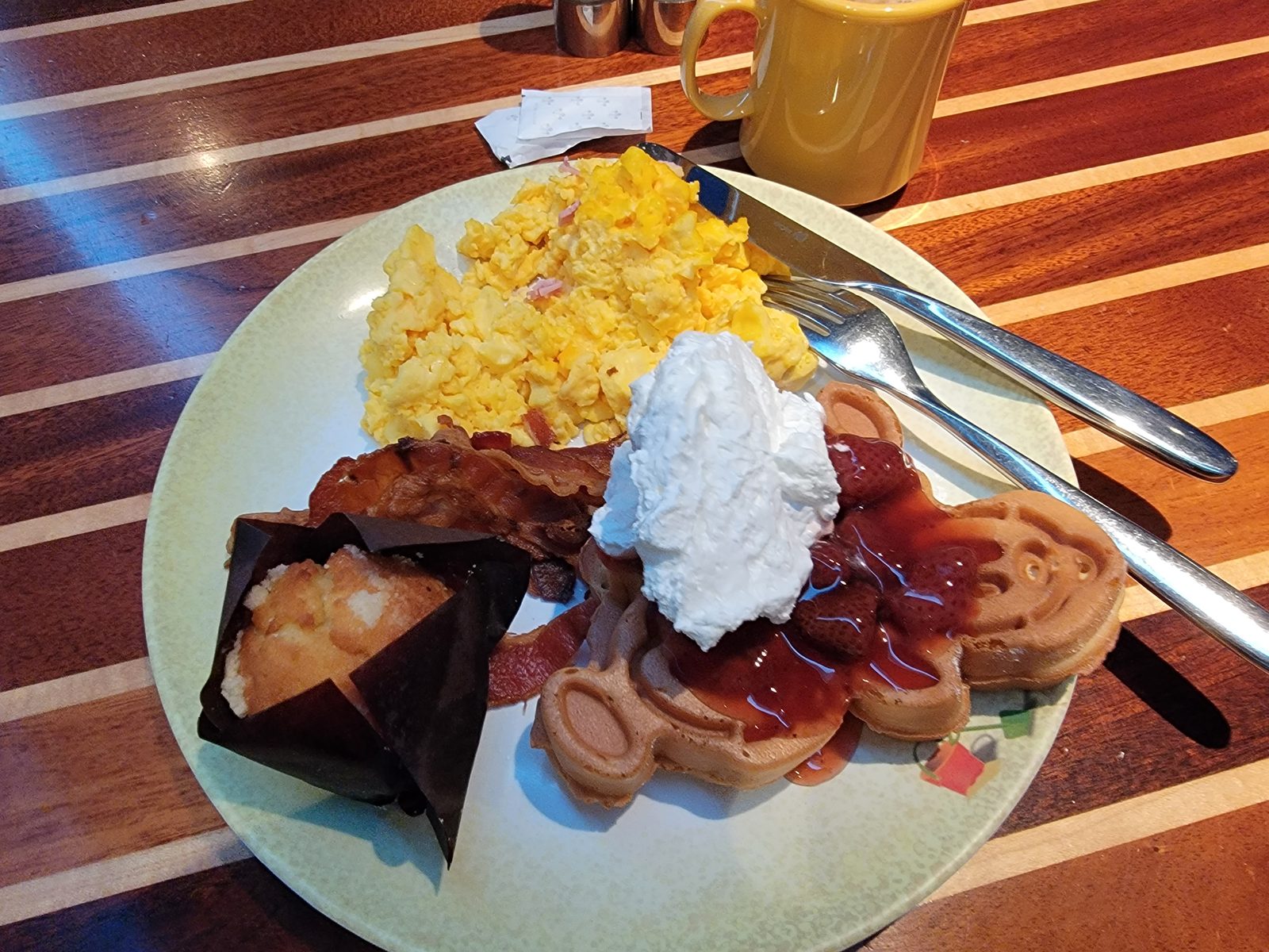Mickey waffle with eggs and bacon for breakfast