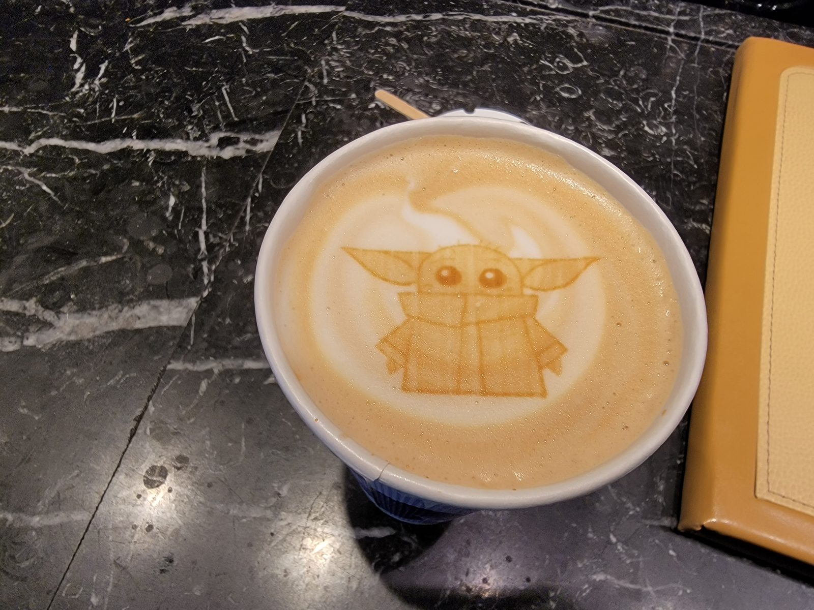 Latte art shaped like Grogu