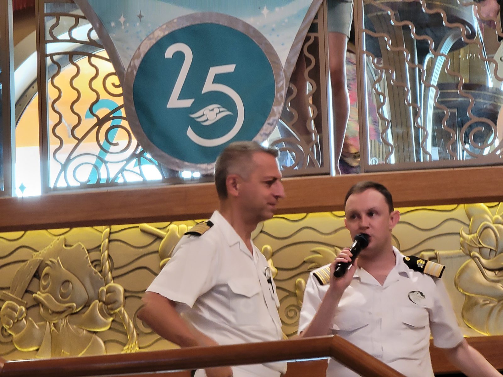 An officer speaks by the anniversary sign