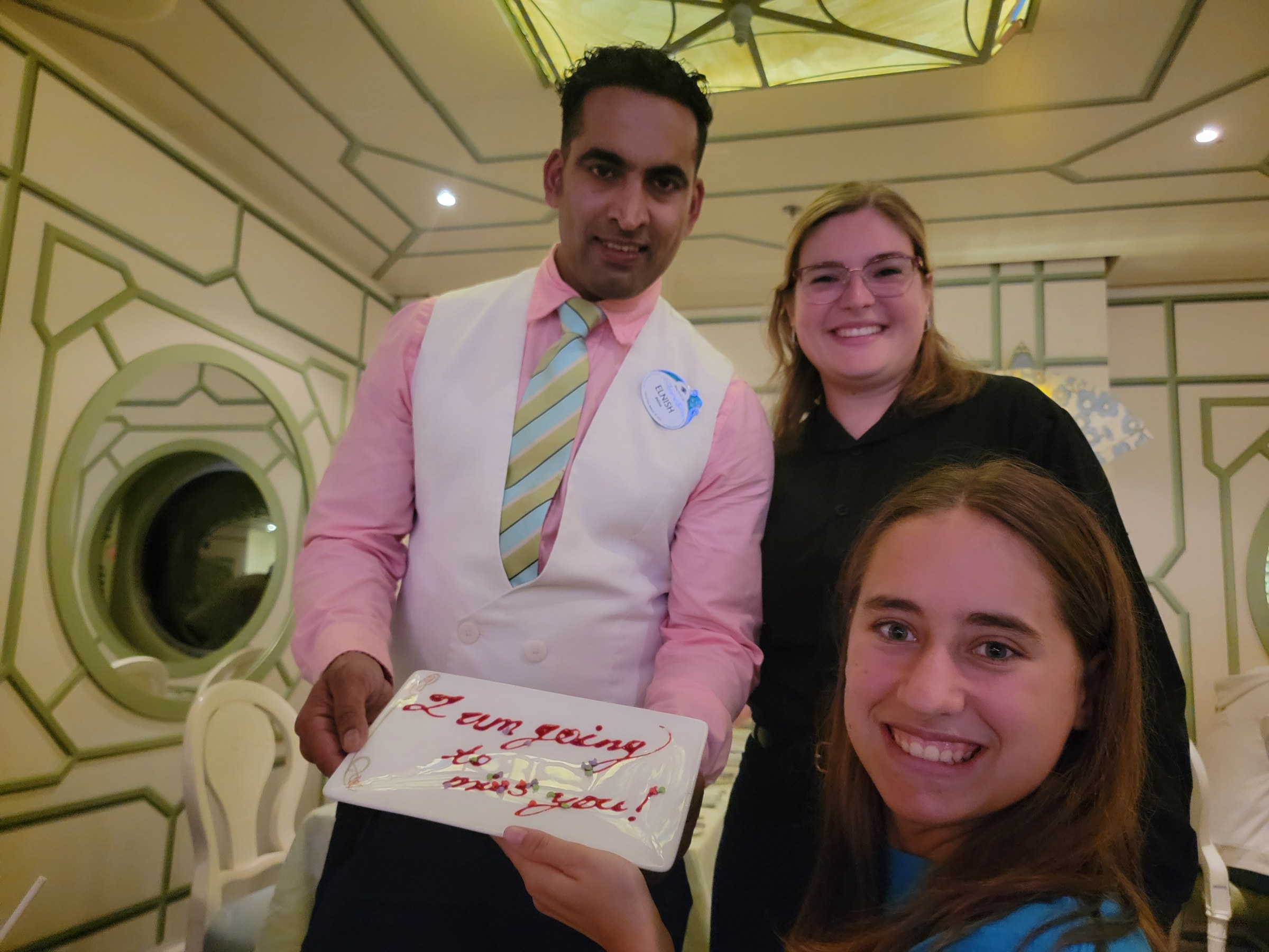 Elnish, our server, with Jenna and Lisa and the plate he wrote us