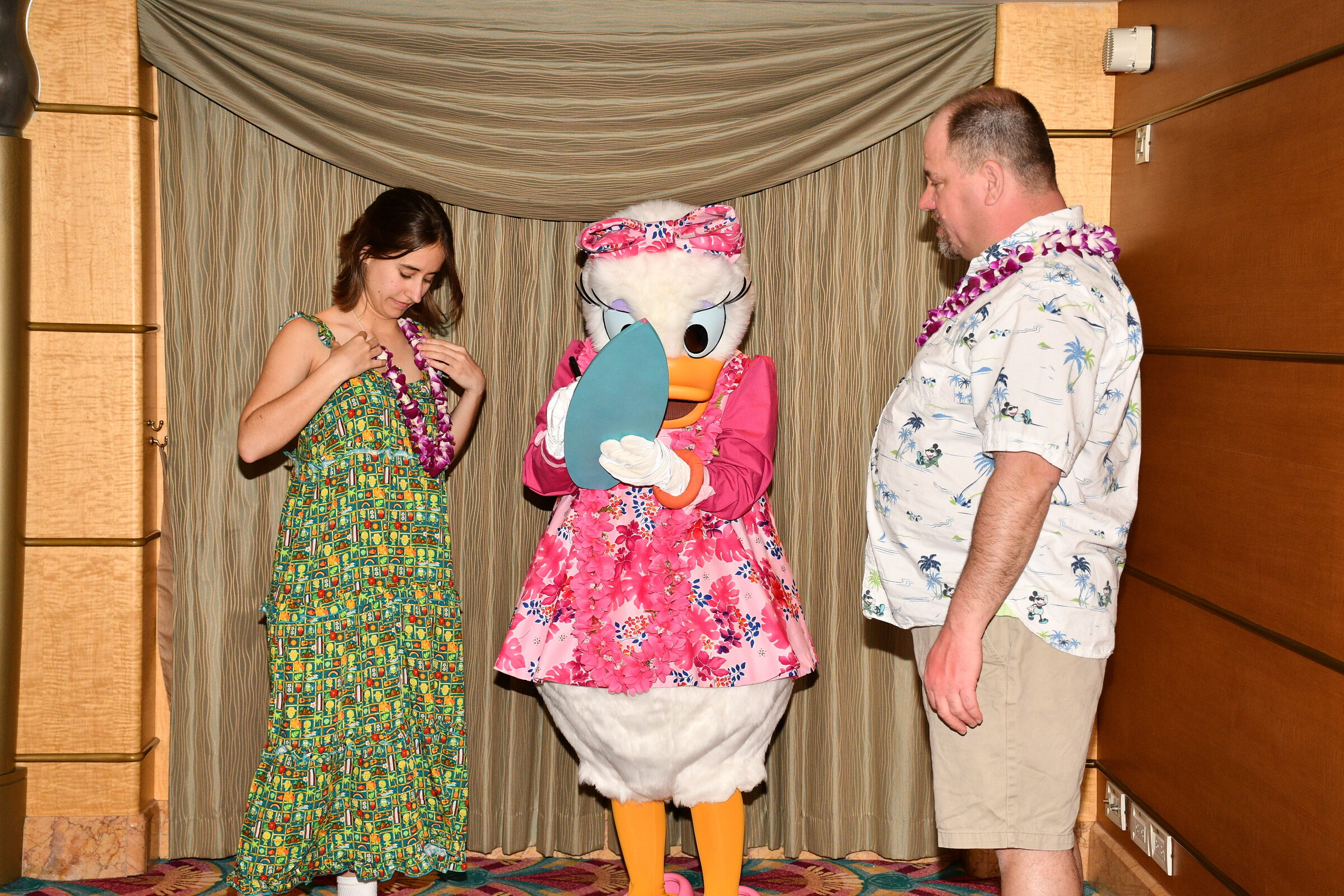 Lisa, Daisy in her pink floral aloha dress with her surfboard & Michael