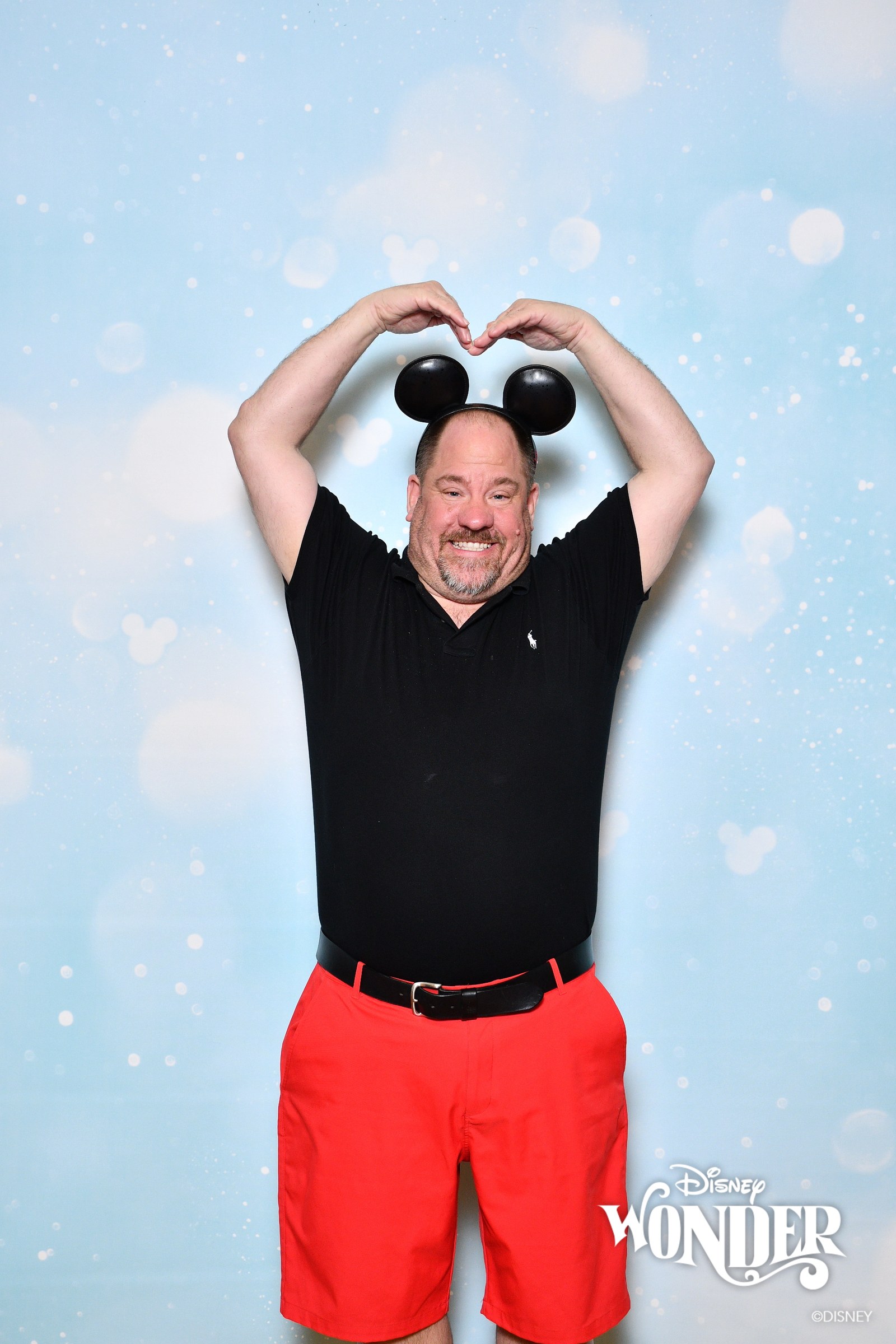 Michael making a heart over his Mickey ears