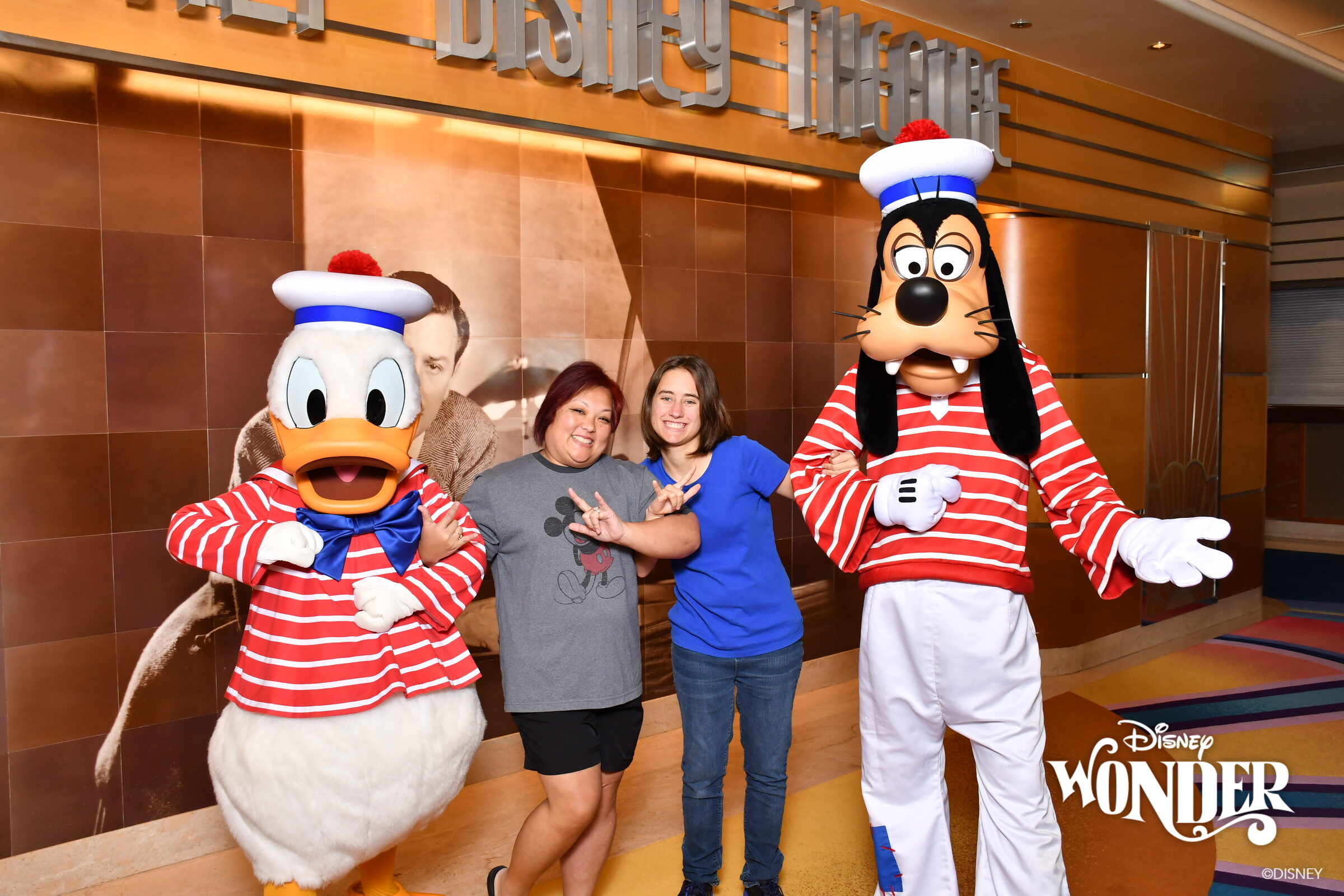 Donald, Lisa & Goofy in their red-striped sailor outfits
