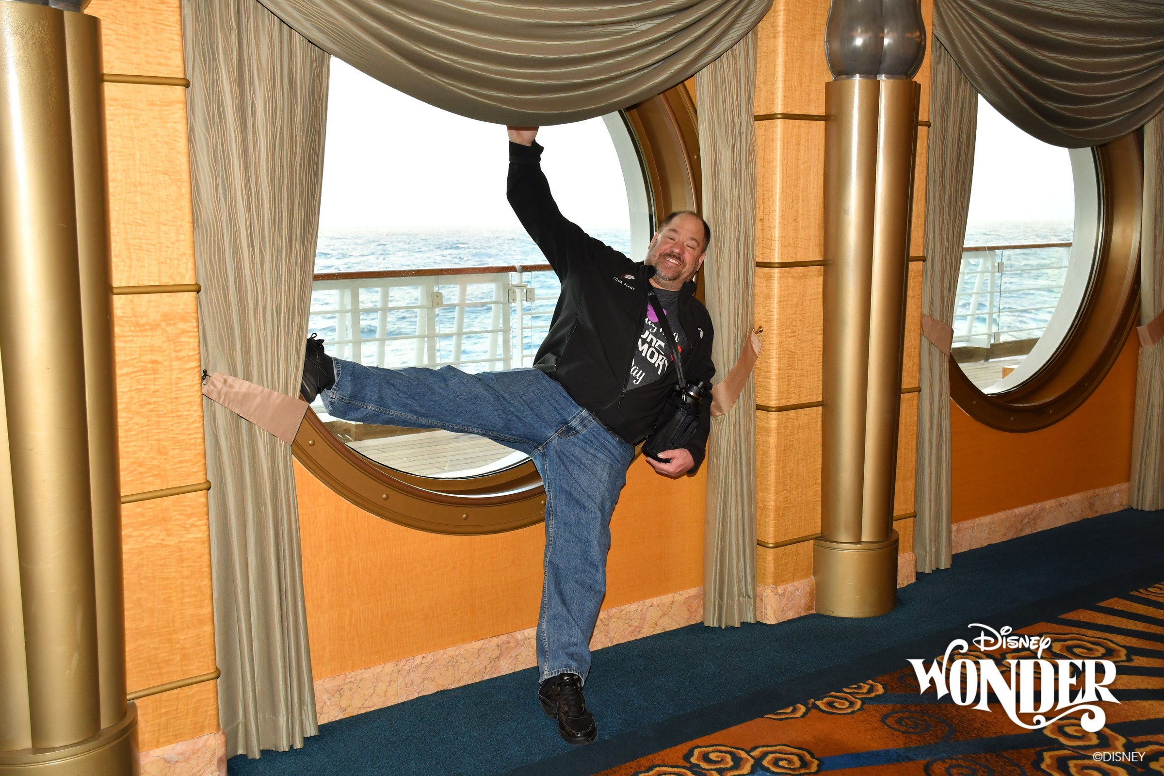 Michael high-kicking in the porthole hallway