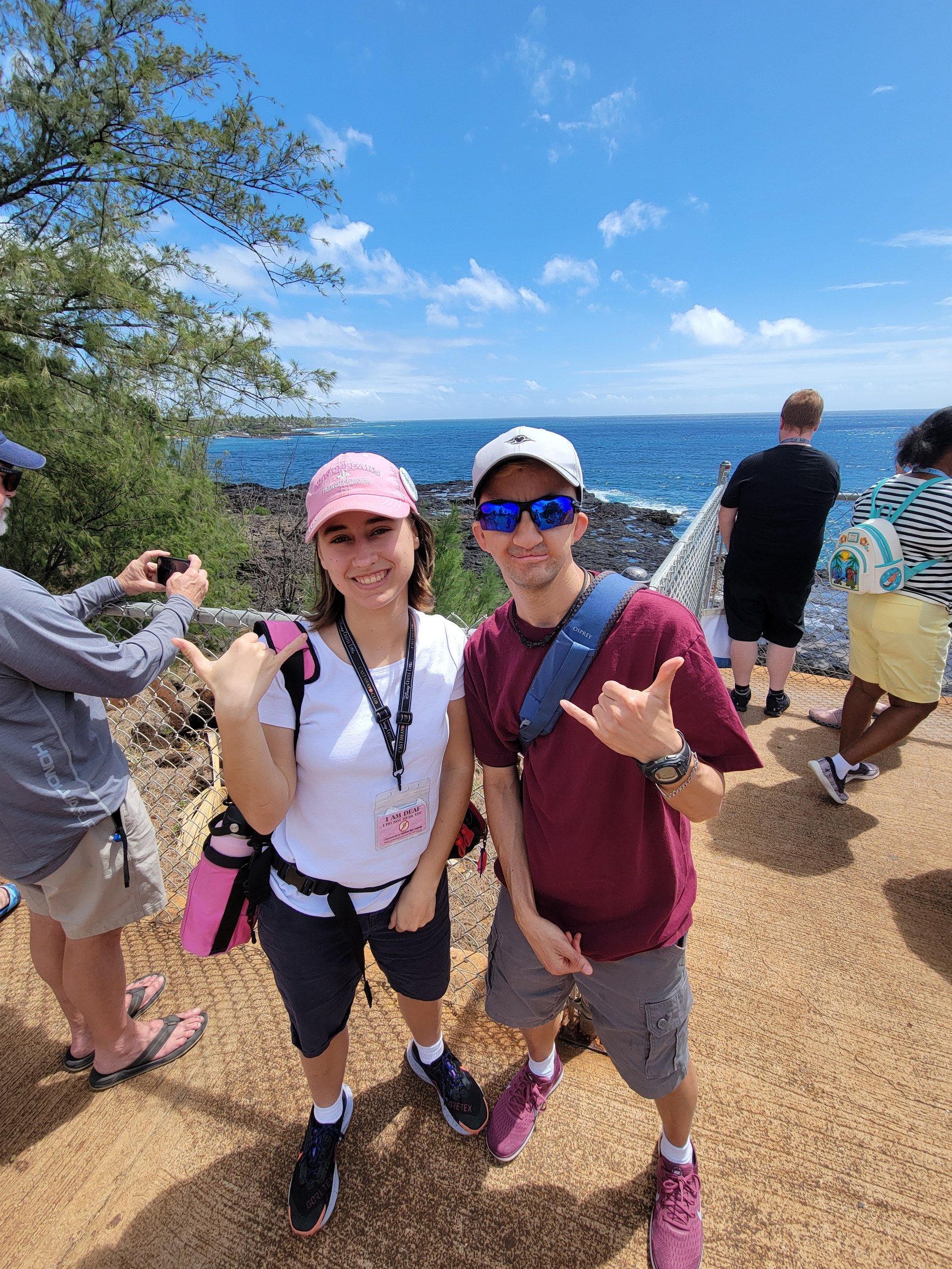 Lisa and Marco throwing shakas on the Kauai coast