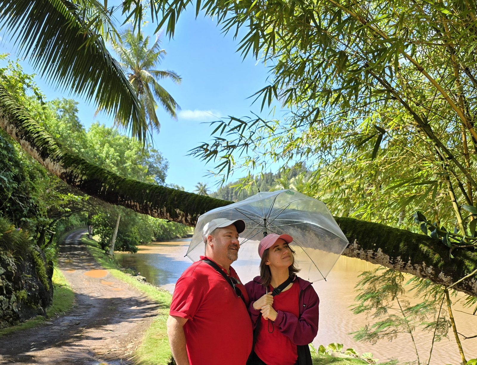 Sharing an umbrella along the river road