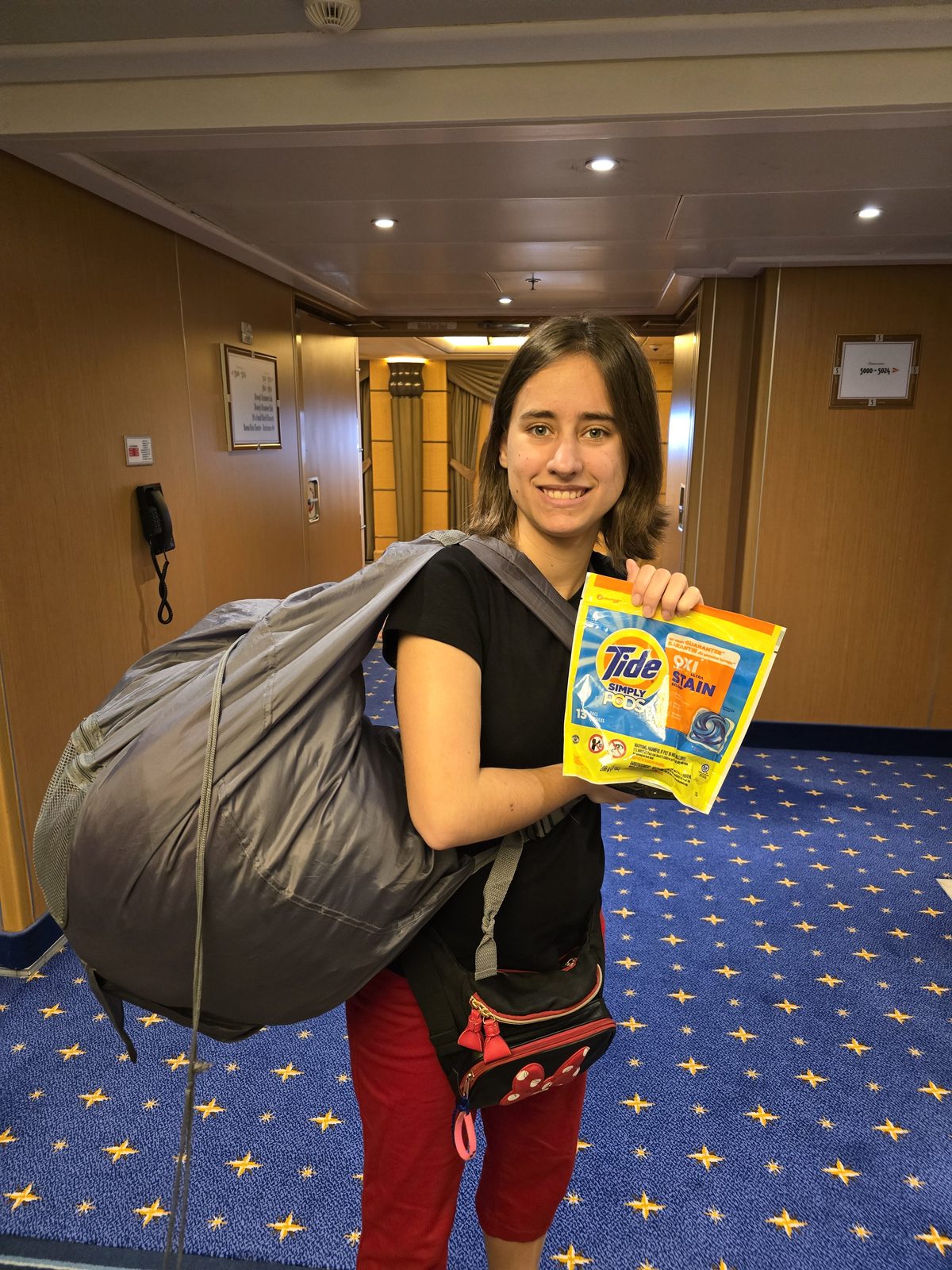 Lisa hauls the laundry down the hall