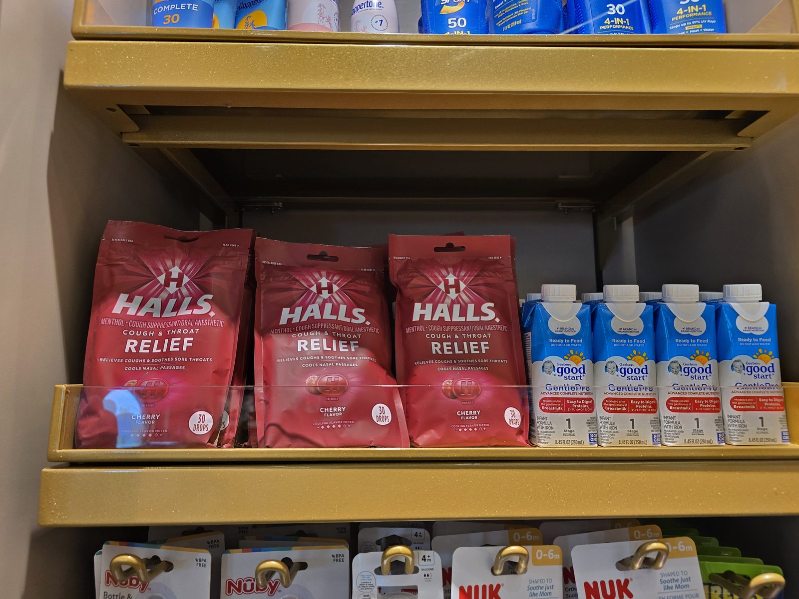 Checking the shop's shelf of Halls and cold medicine