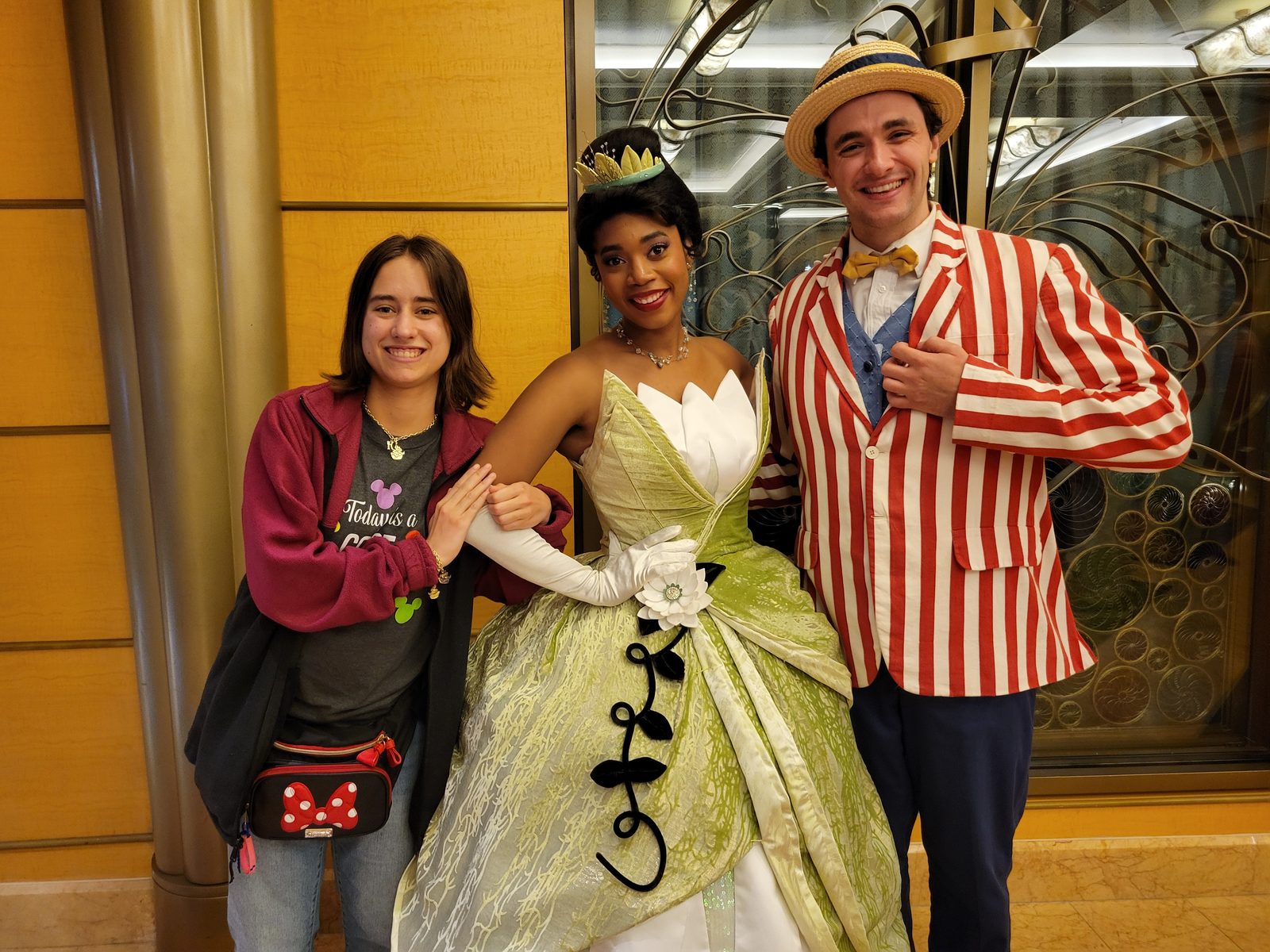 Lisa with Tiana and Prince Naveen in his striped jacket and boater