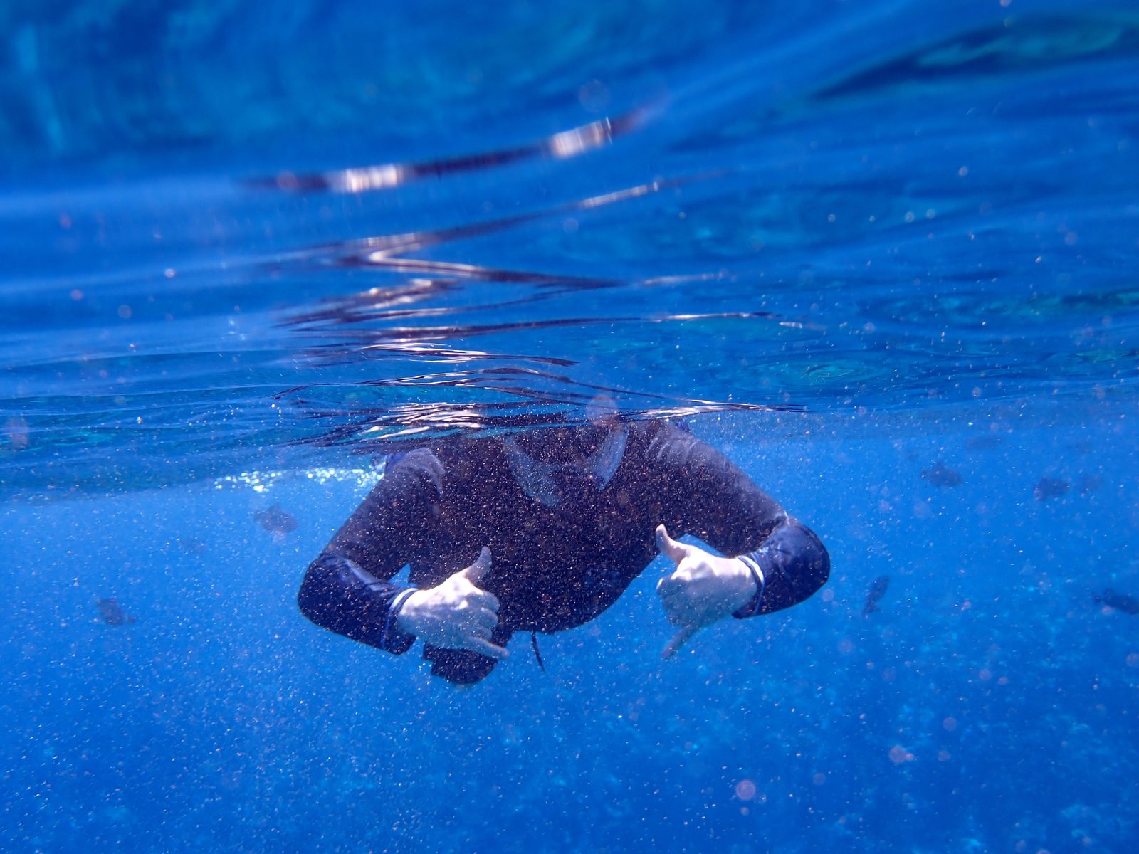Thumbs up from just below the surface at Molokini