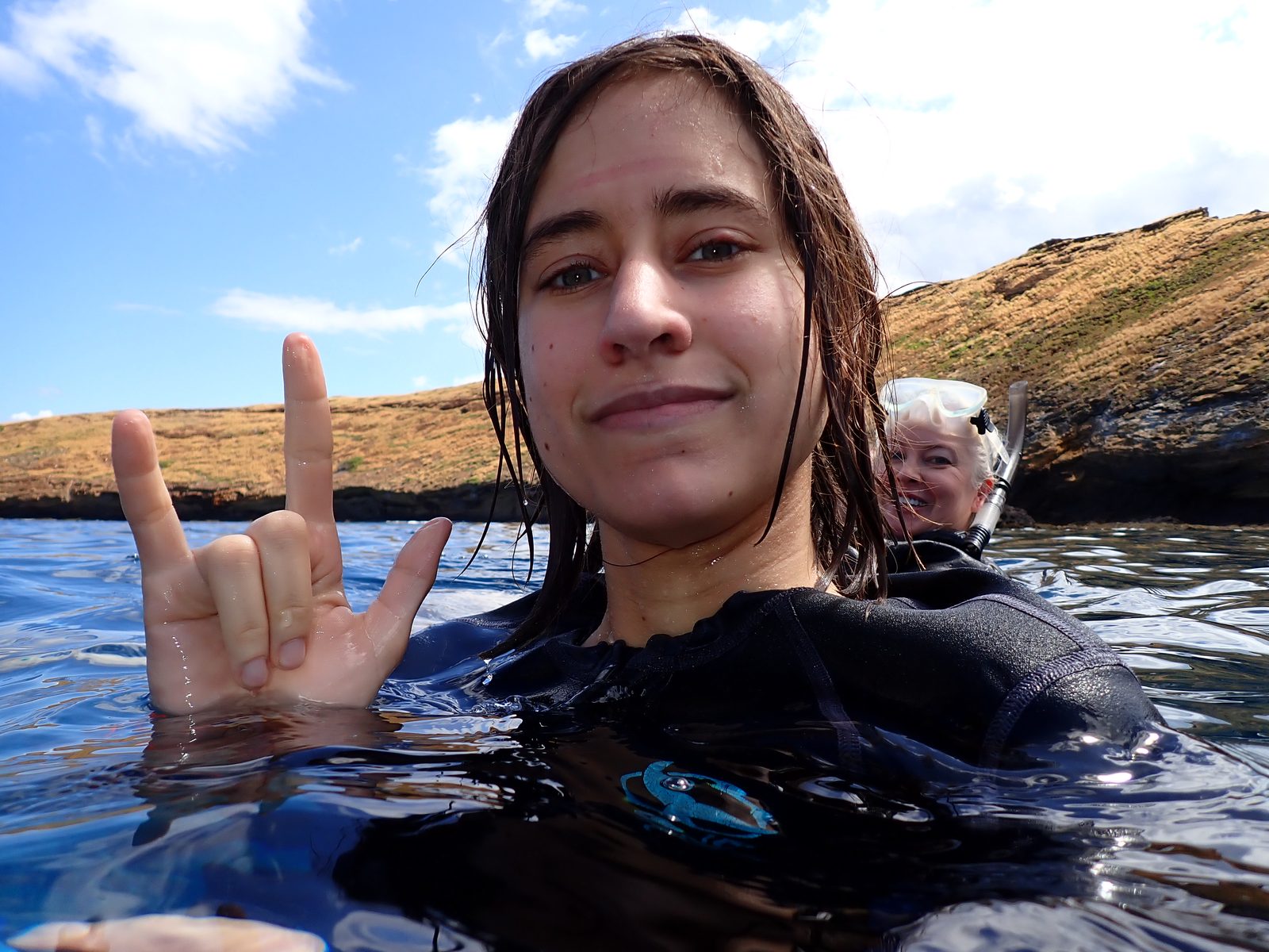 Lisa signs I love you snorkeling at Molokini