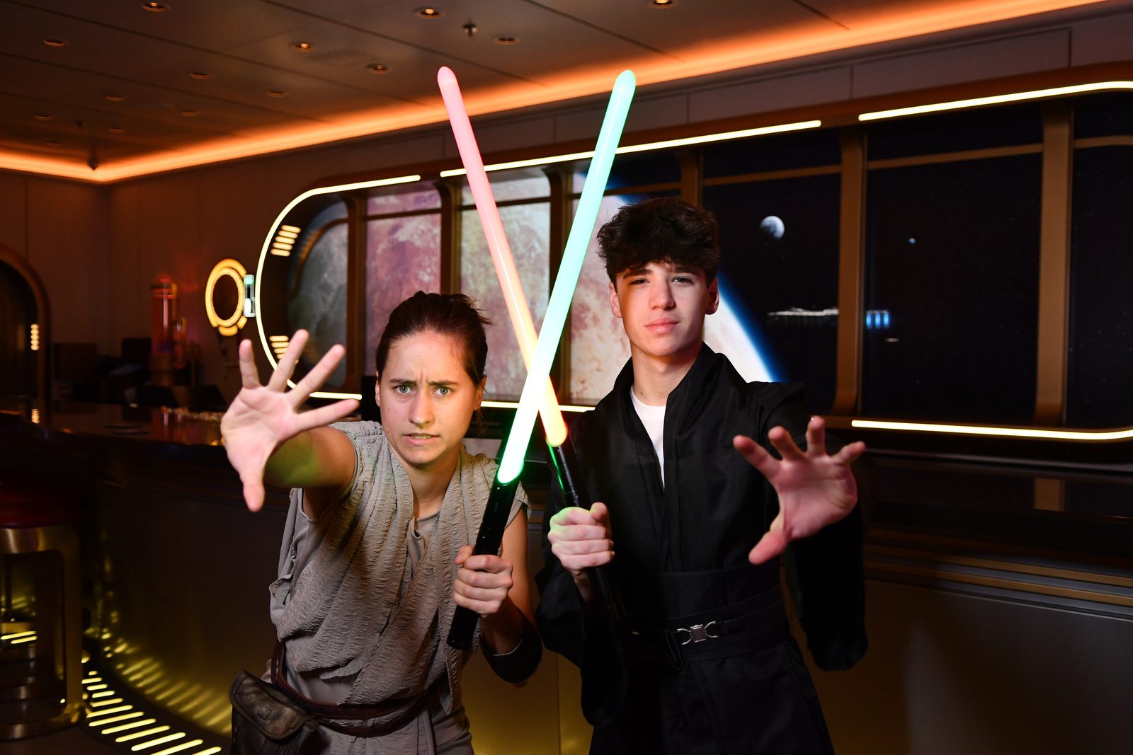 Lisa and Thomas duel with lightsabers