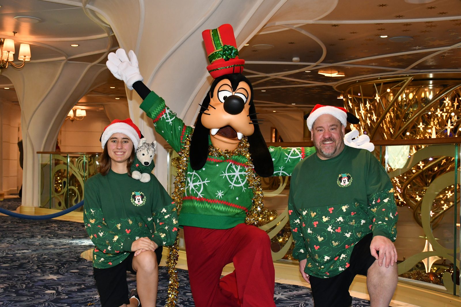 Lisa with Bob and Michael in Santa hats with Goofy in his Christmas sweater