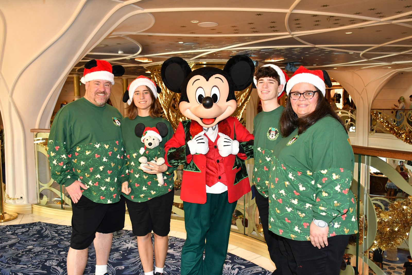 Michael, Lisa holding Bob, Mickey Mouse in his Christmas outfit, Thomas & Kathy, all in Very Merrytime sweaters
