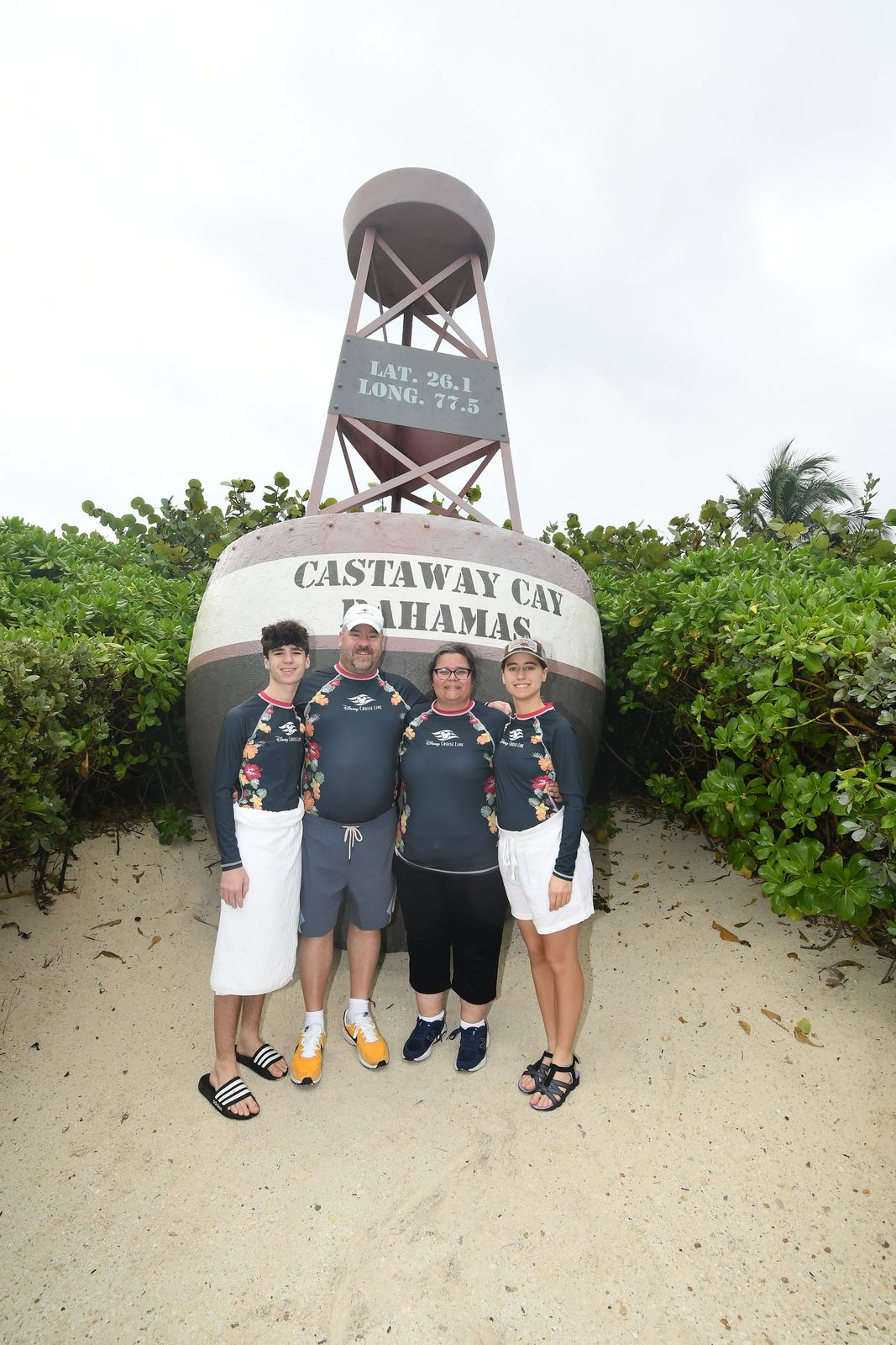 The family at the Castaway Cay sign