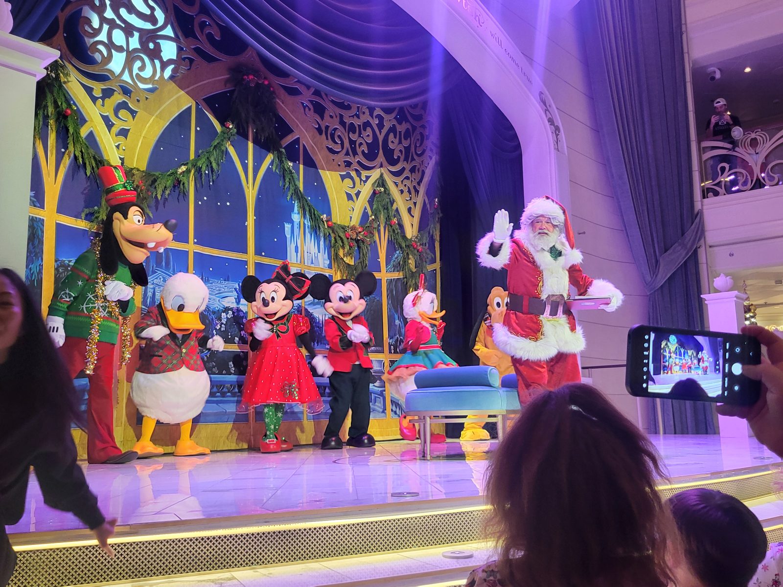 Goofy, Donald, Minnie, Mickey, Daisy and Santa Claus in their Christmas outfits at Mickey and Minnie's Holiday Party