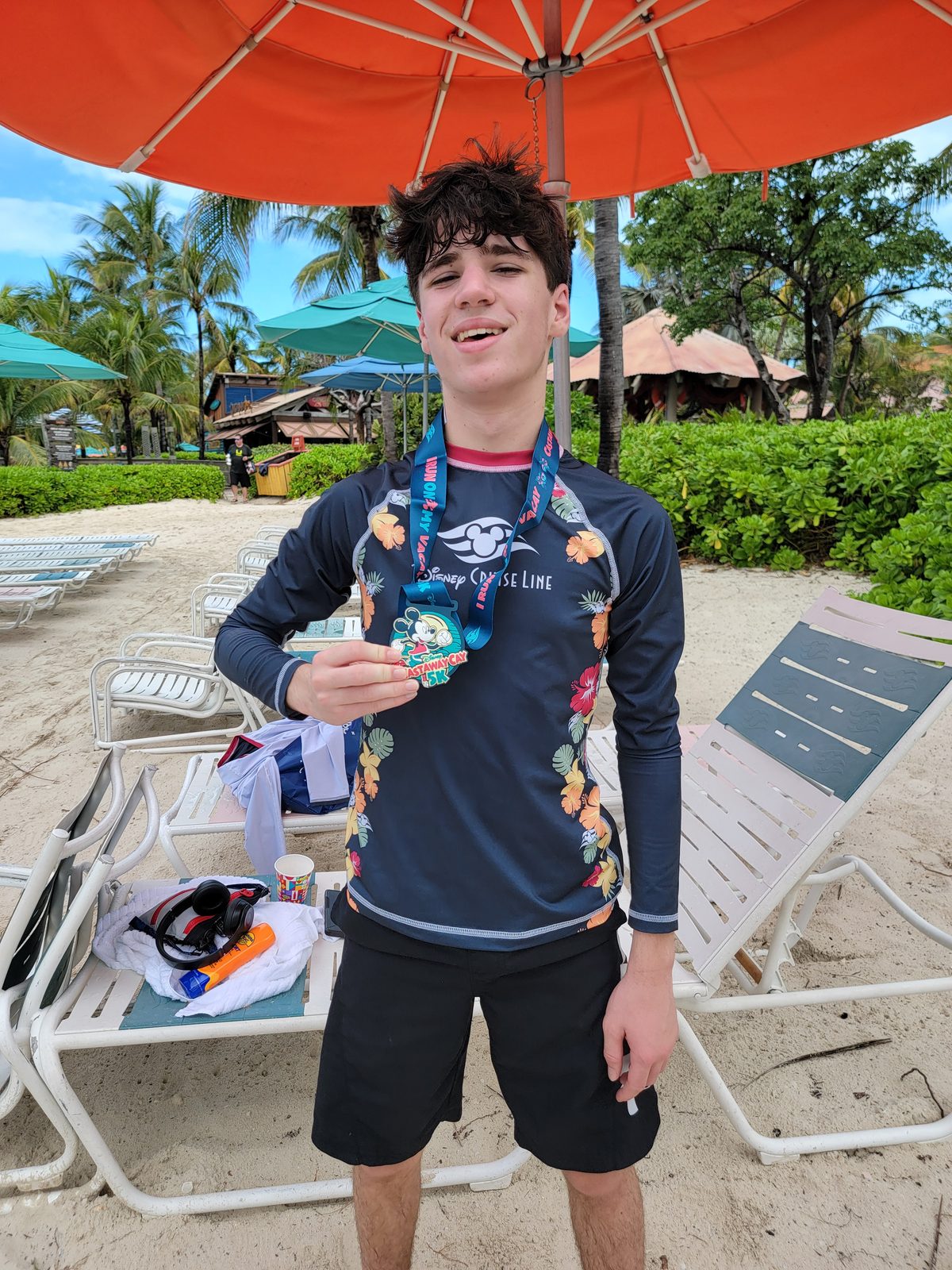 Thomas with his 5K medal at Castaway Cay