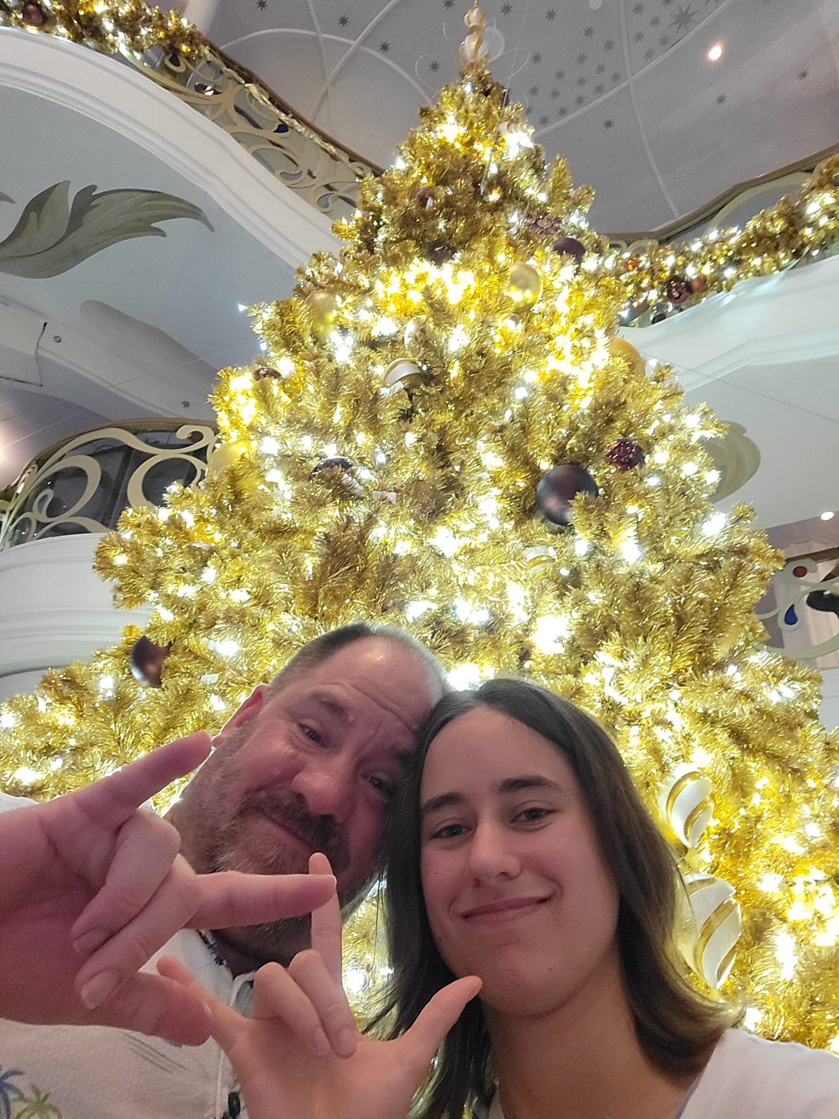 Lisa and me signing I love you by the gold tree
