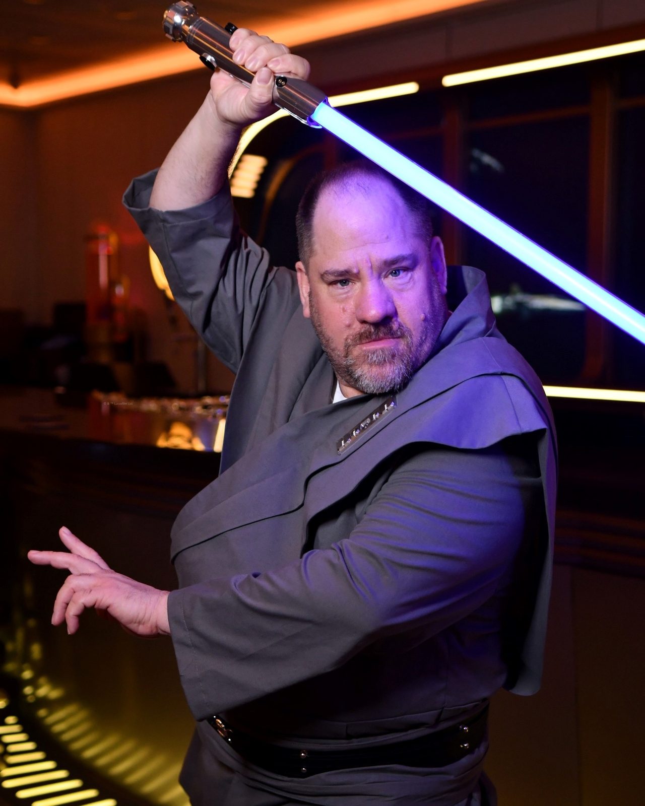 Michael with a lightsaber in the Hyperspace Lounge on the Wish