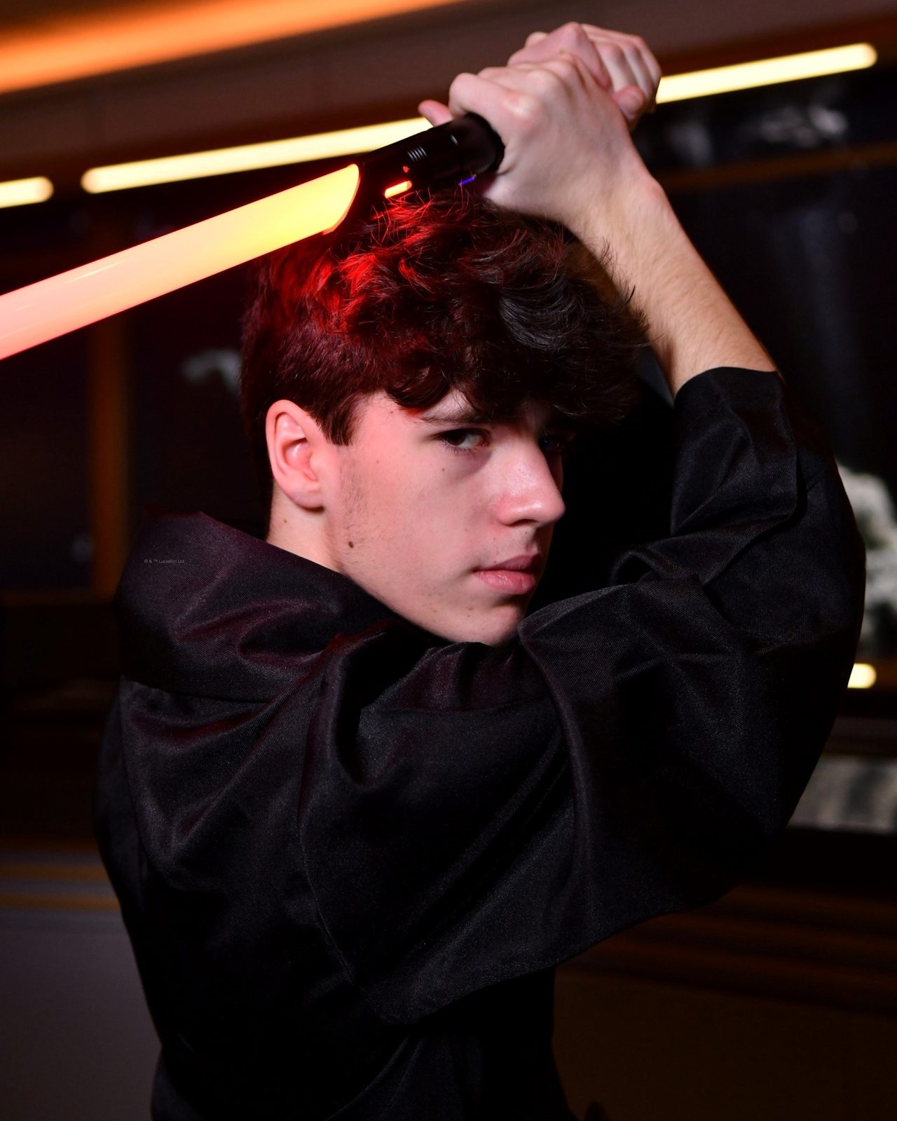 Thomas with a lightsaber in the Hyperspace Lounge