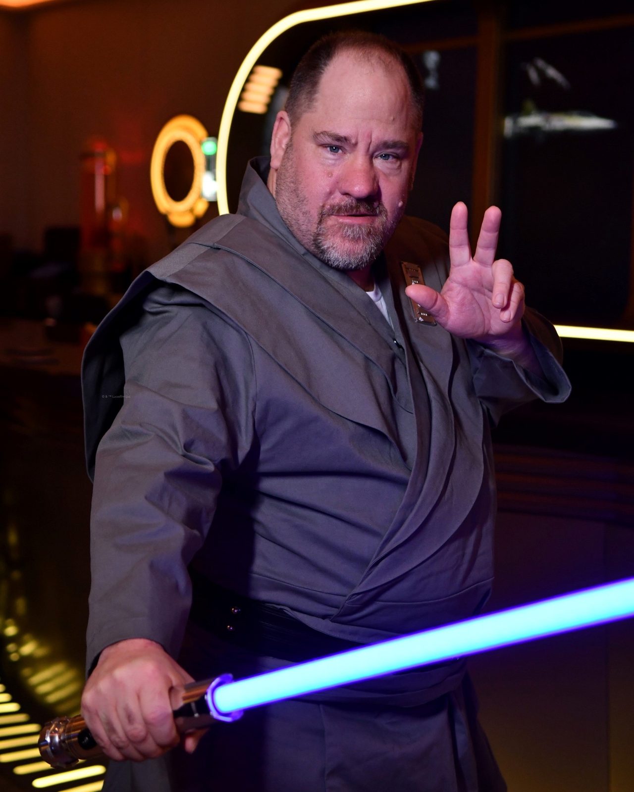 Michael with a lightsaber in the Hyperspace Lounge