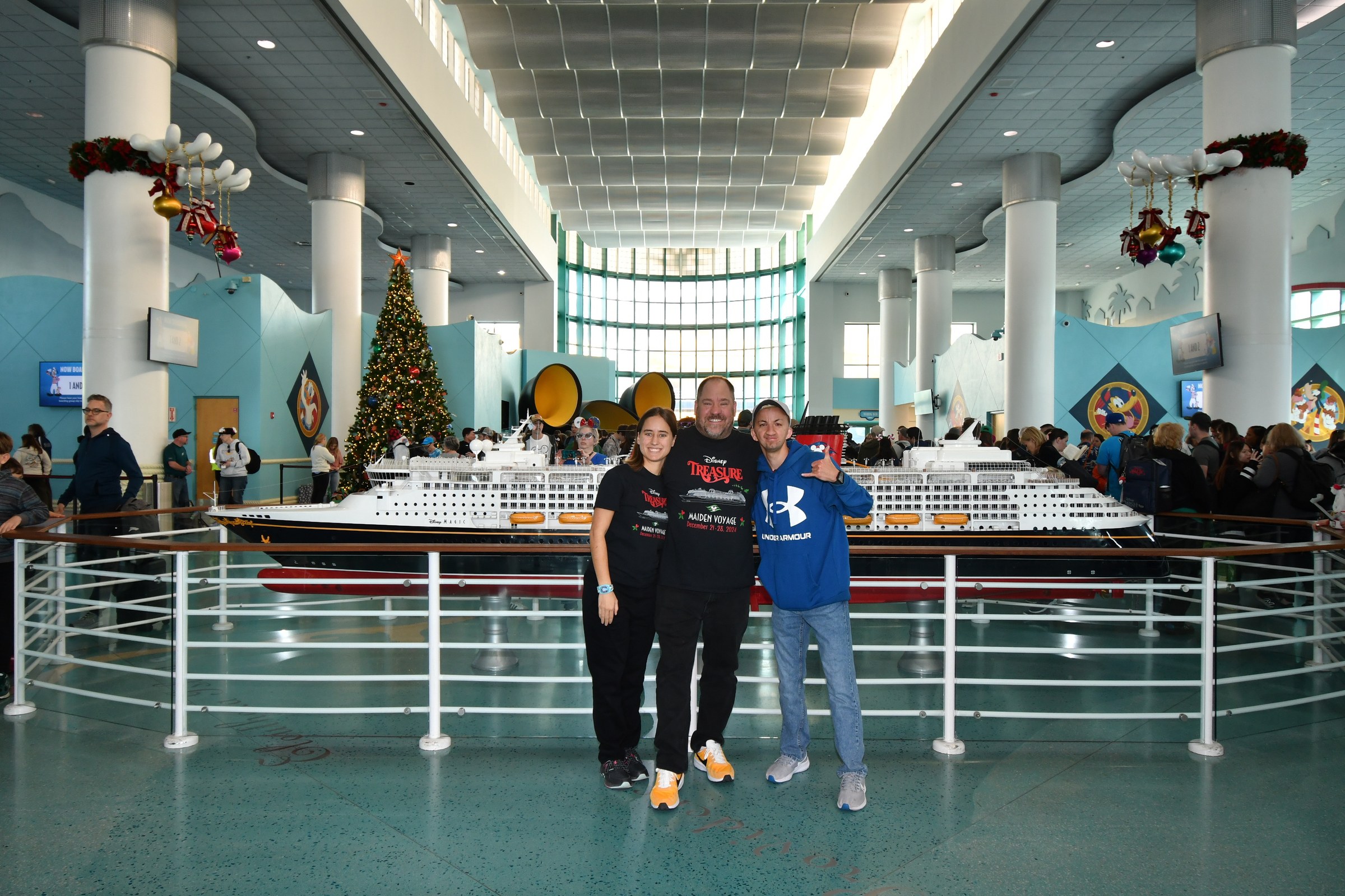 Lisa, Michael and Marco by the ship model in the terminal on boarding day