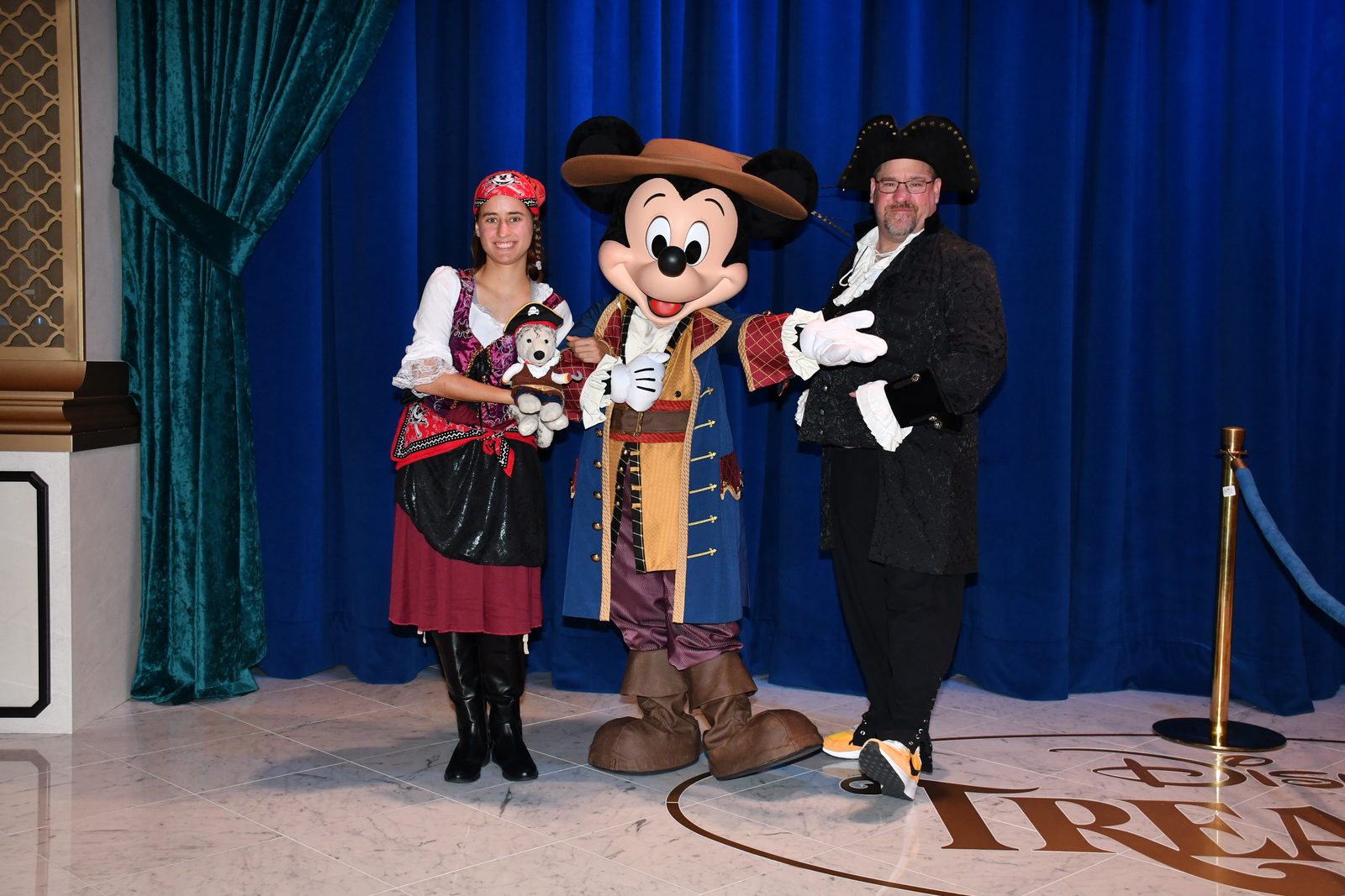 Lisa with Bob, Mickey Mouse in pirate garb & Michael in their pirate outfits on Pirate Night