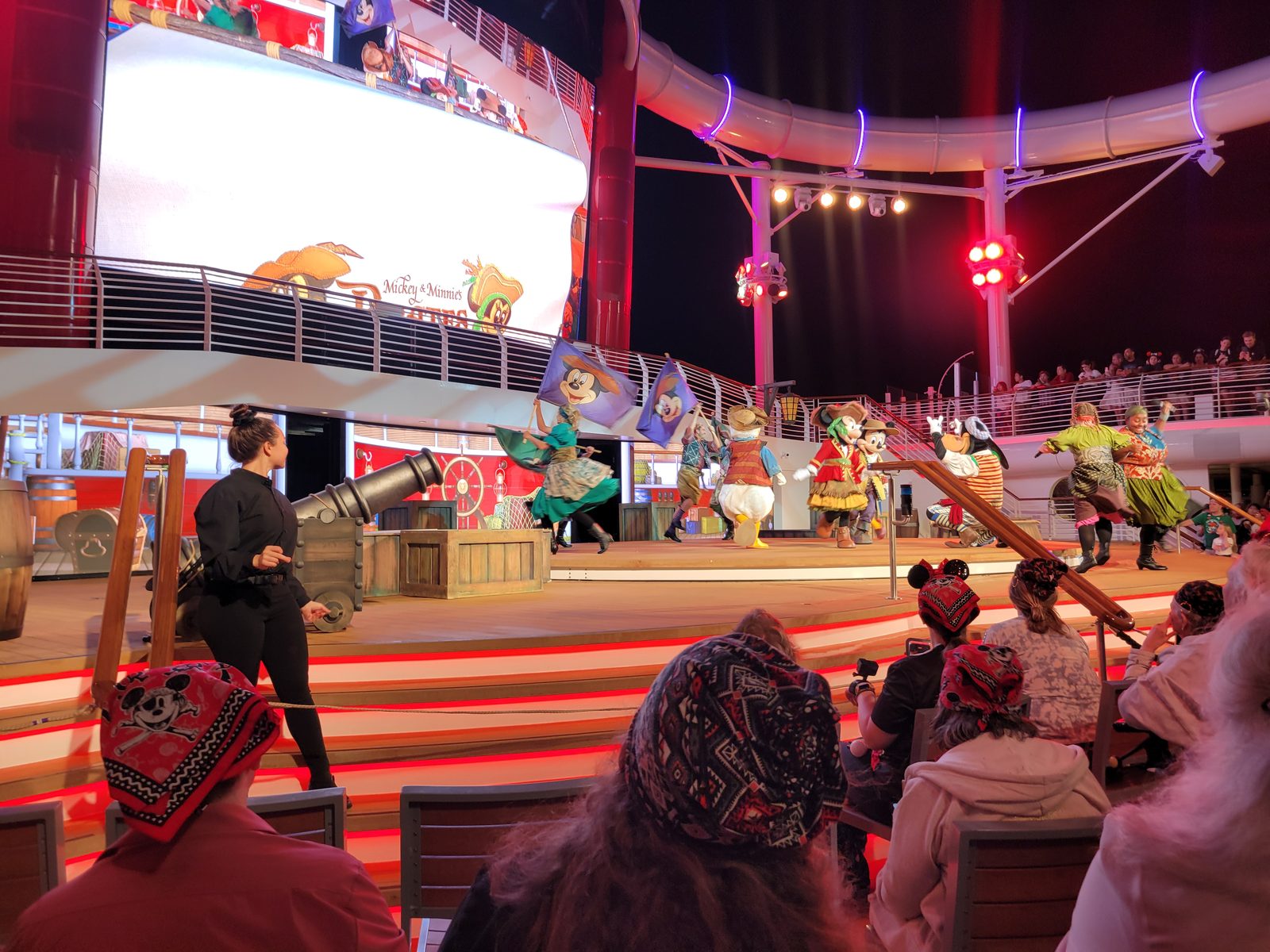Stephanie signing the Pirate Night deck party with the characters in pirate garb
