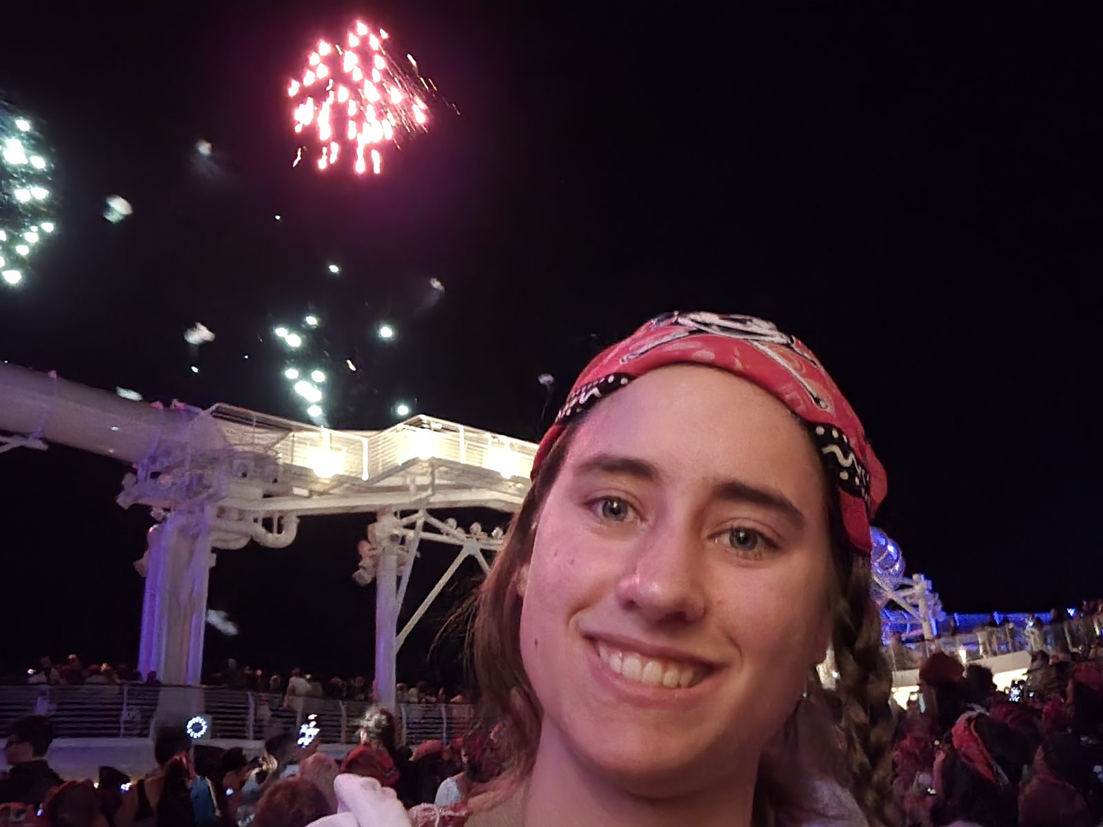 Lisa smiling with the fireworks behind her