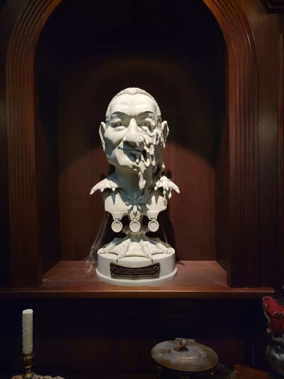 The bust in an alcove of the Haunted Mansion Parlor