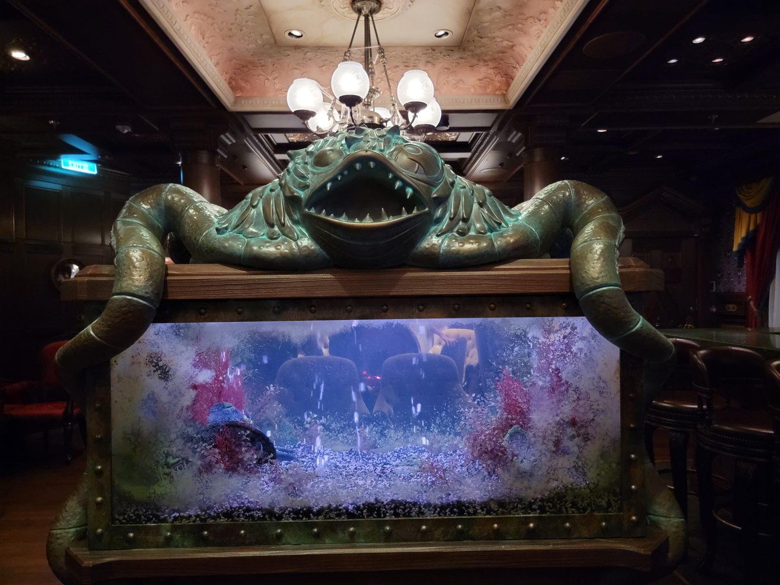 The frog over the fish tank in the Haunted Mansion Parlor