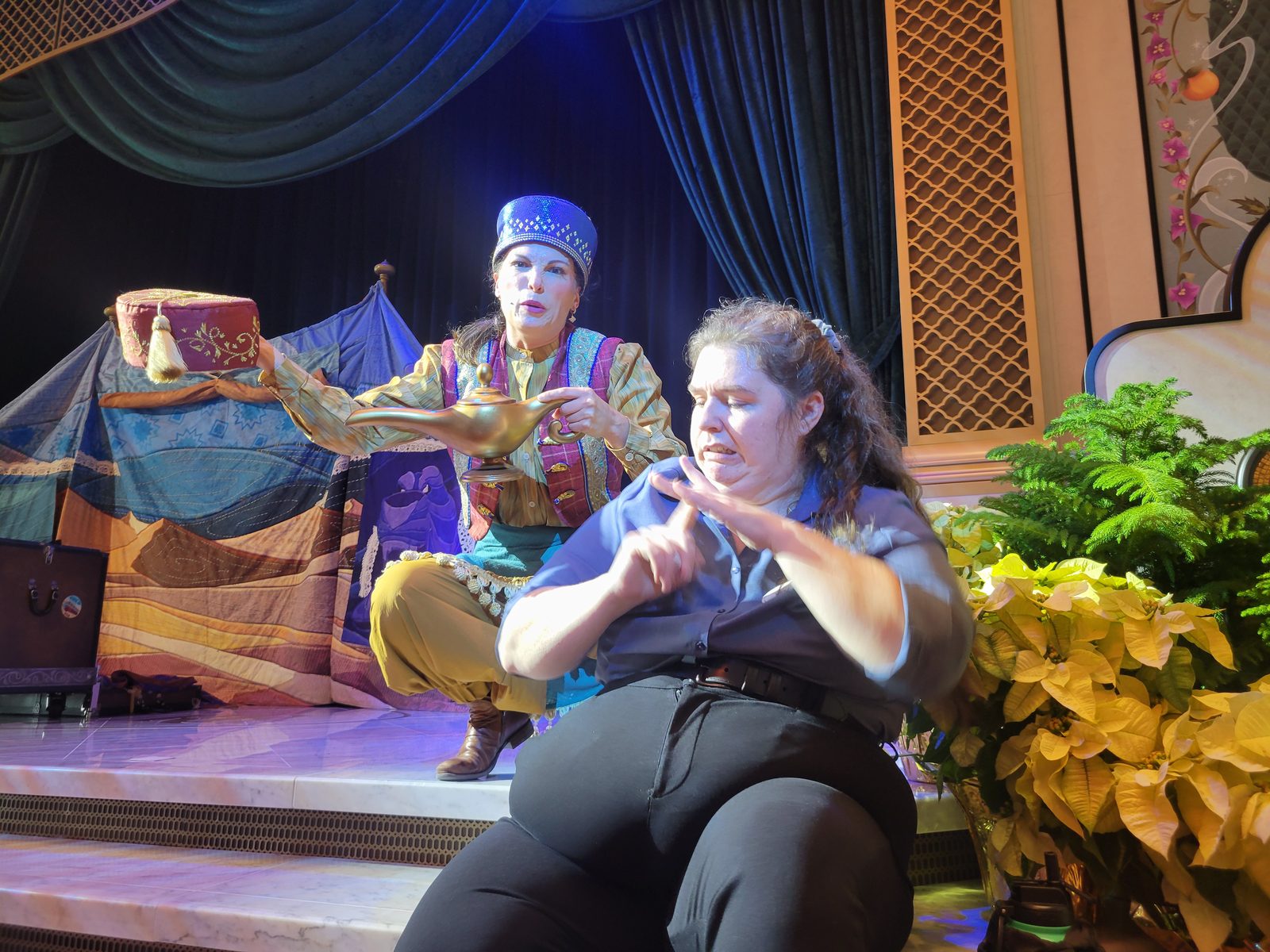 Coriander in her Arabian costume telling the genie's tale, with Kelly signing