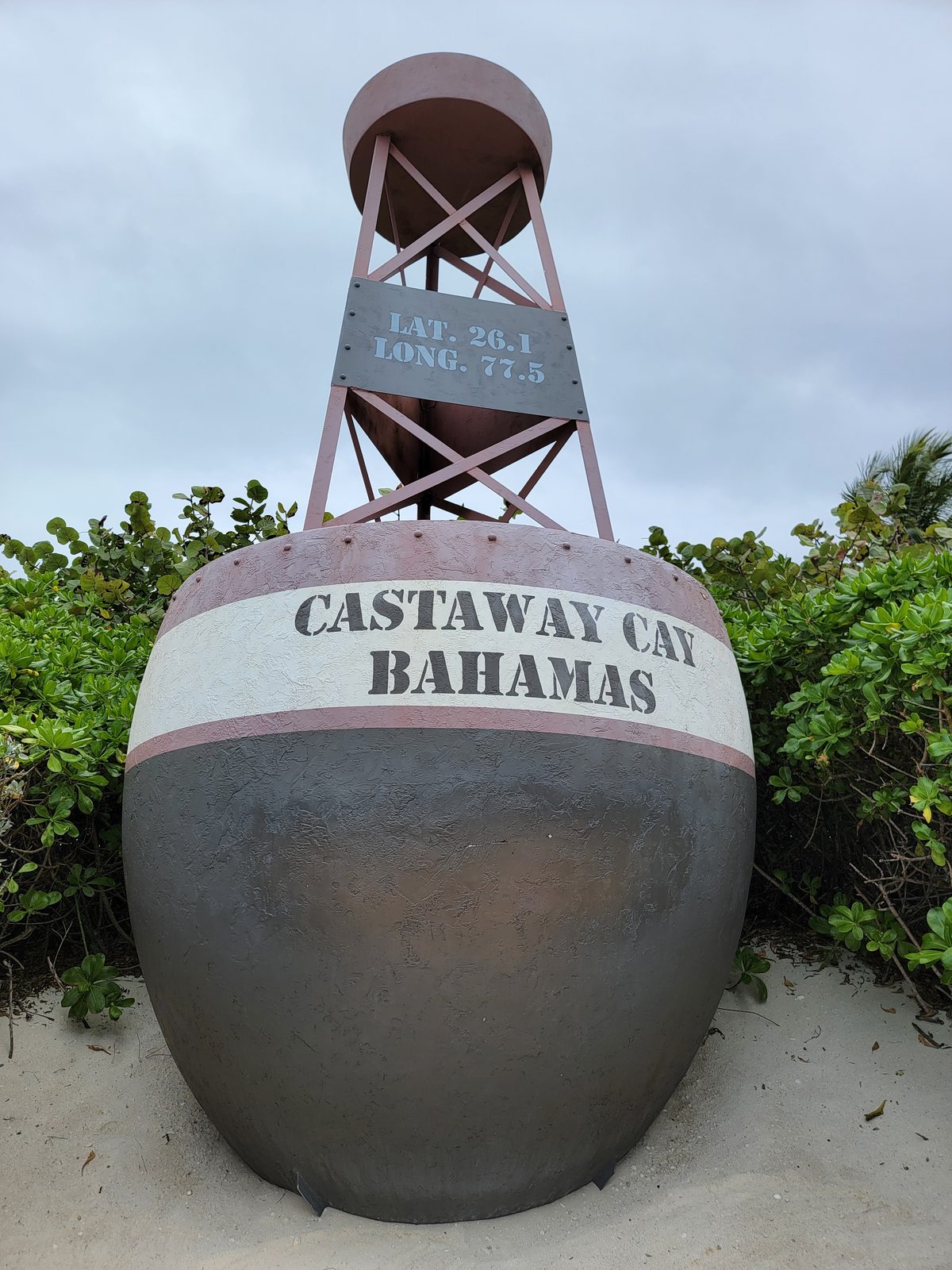 The Castaway Cay buoy on the sand