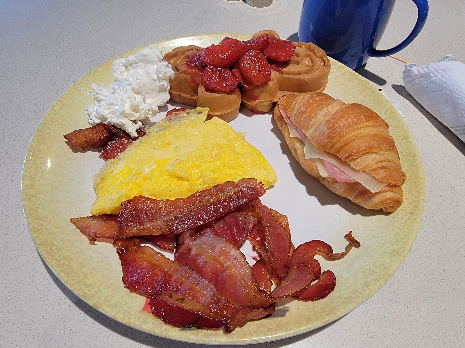 Breakfast of eggs, bacon and a croissant before going ashore